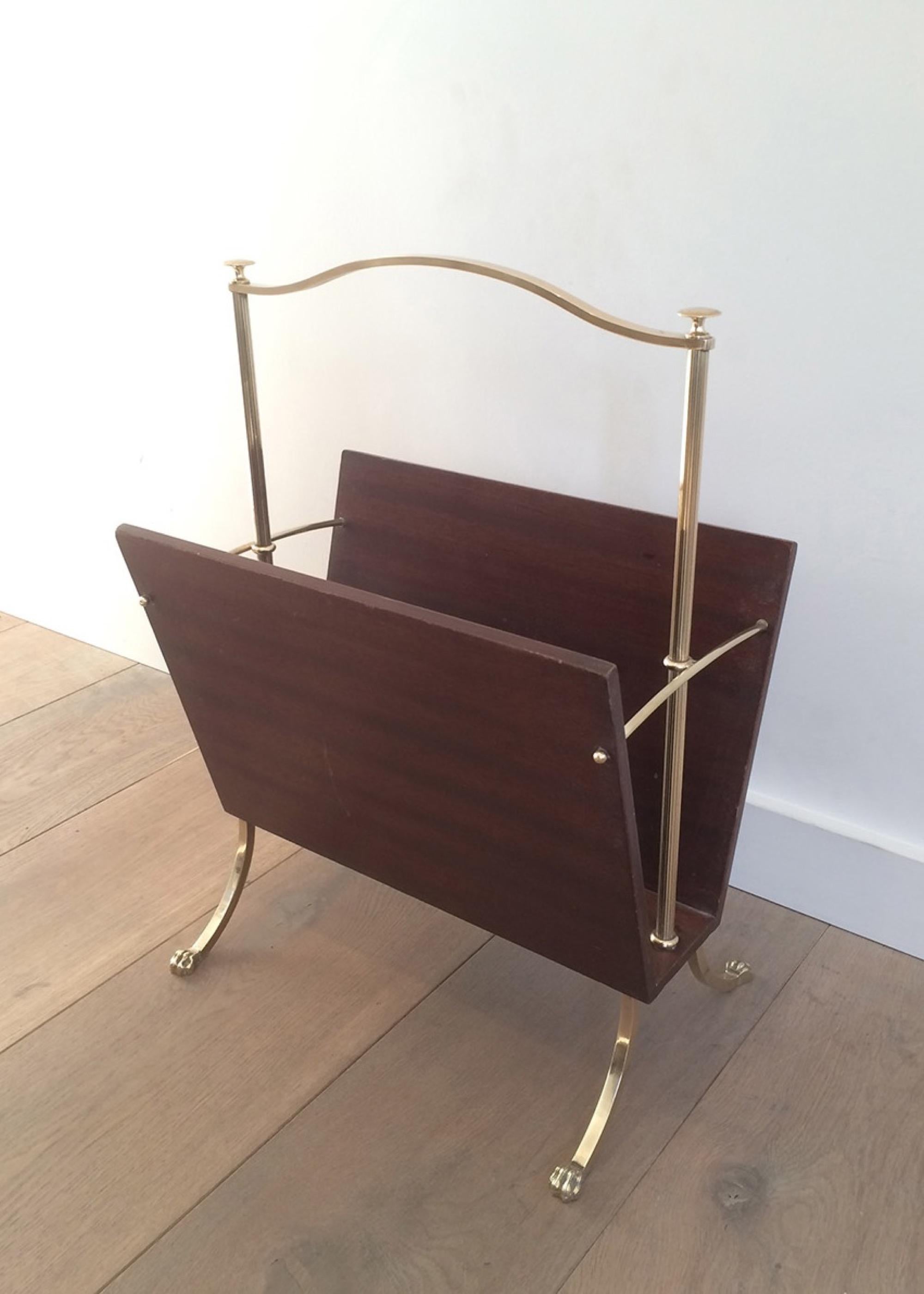 This nice magazine rack is made of wood and brass with claw feet. This is a French work by famous designer Maison Jansen, circa 1940.