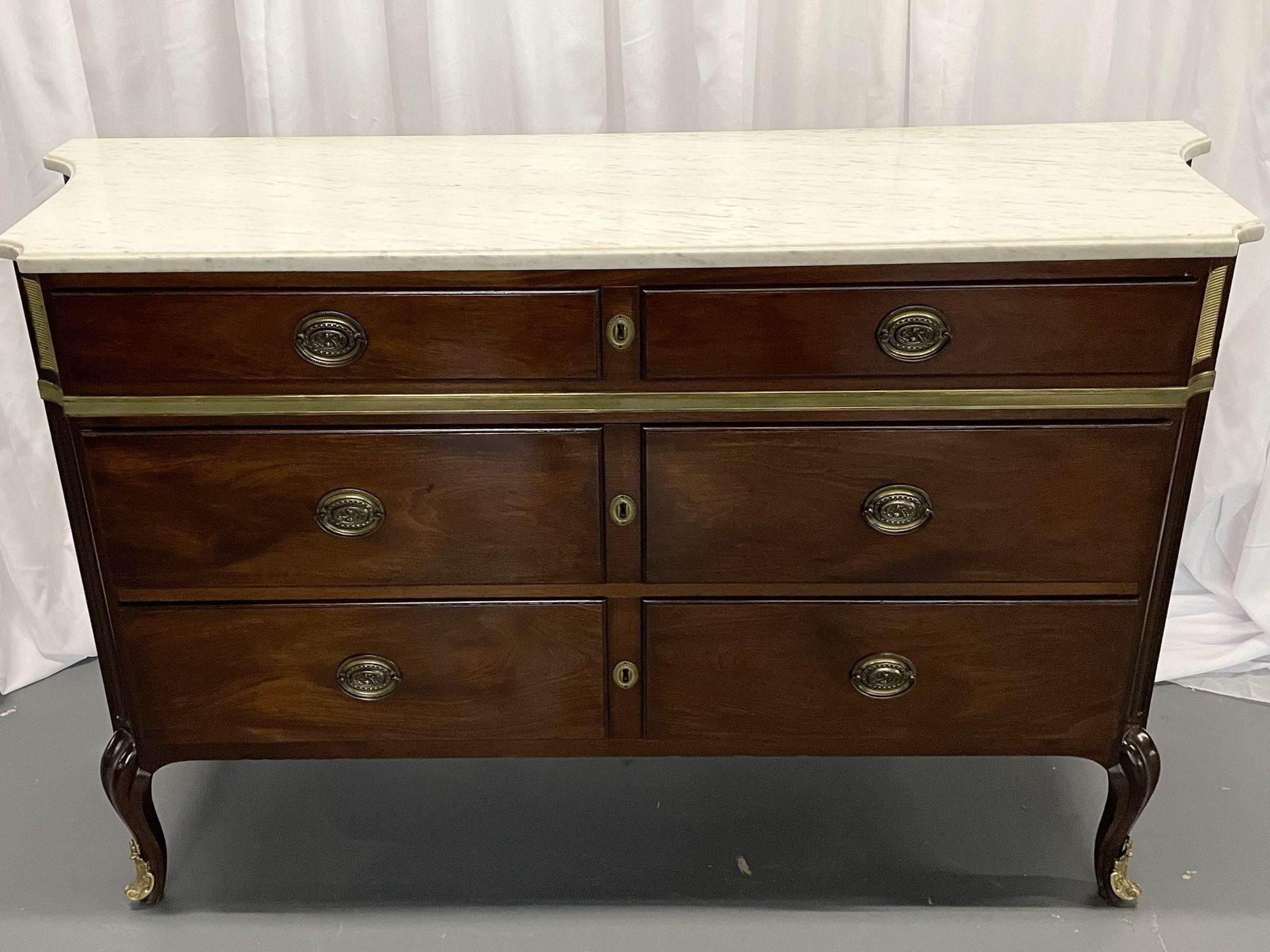 Maison Jansen Mahogany Commode or Chest, Bronze Mounted, Directoire Style, 1940s


A Jansen commode having two larger drawers under a smaller drawer with inverted sides and bronze mounts. The whole supporting a white and gray vein marble top. This