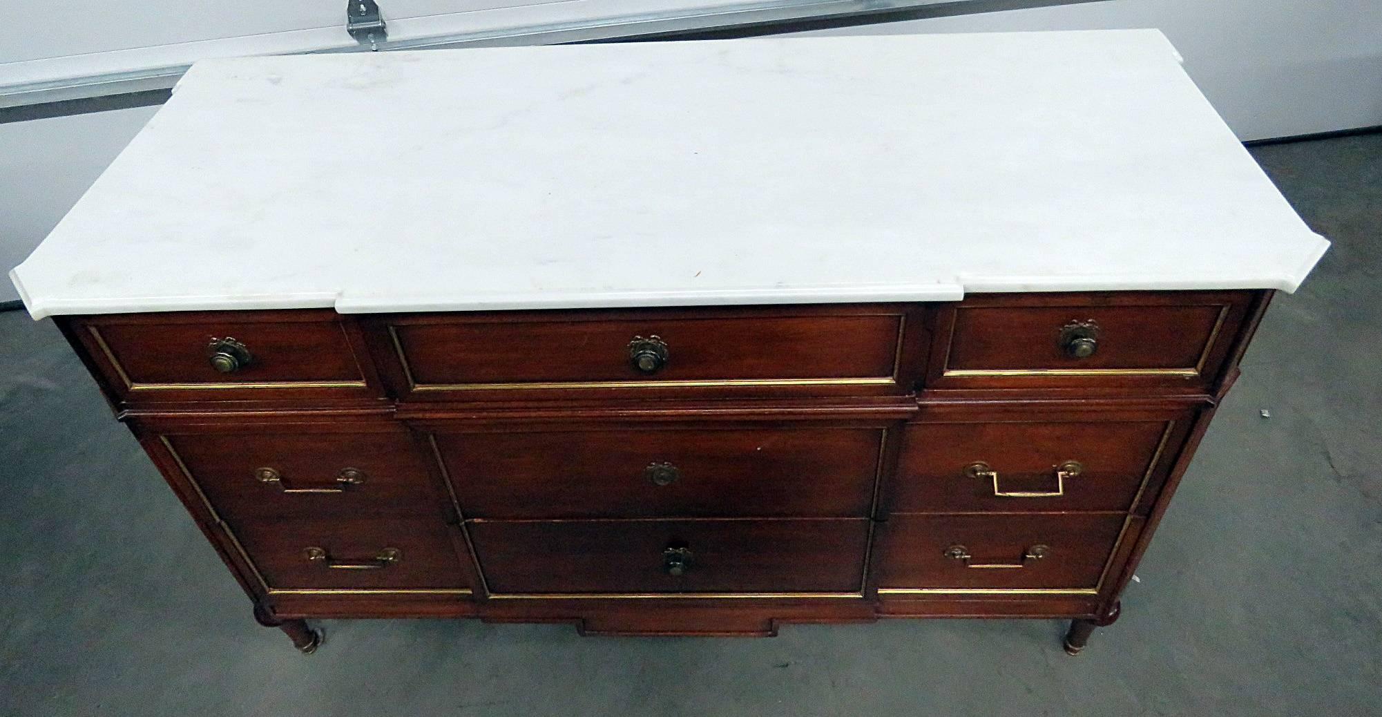 Maison Jansen marble top nine-drawer commode with brass accents.