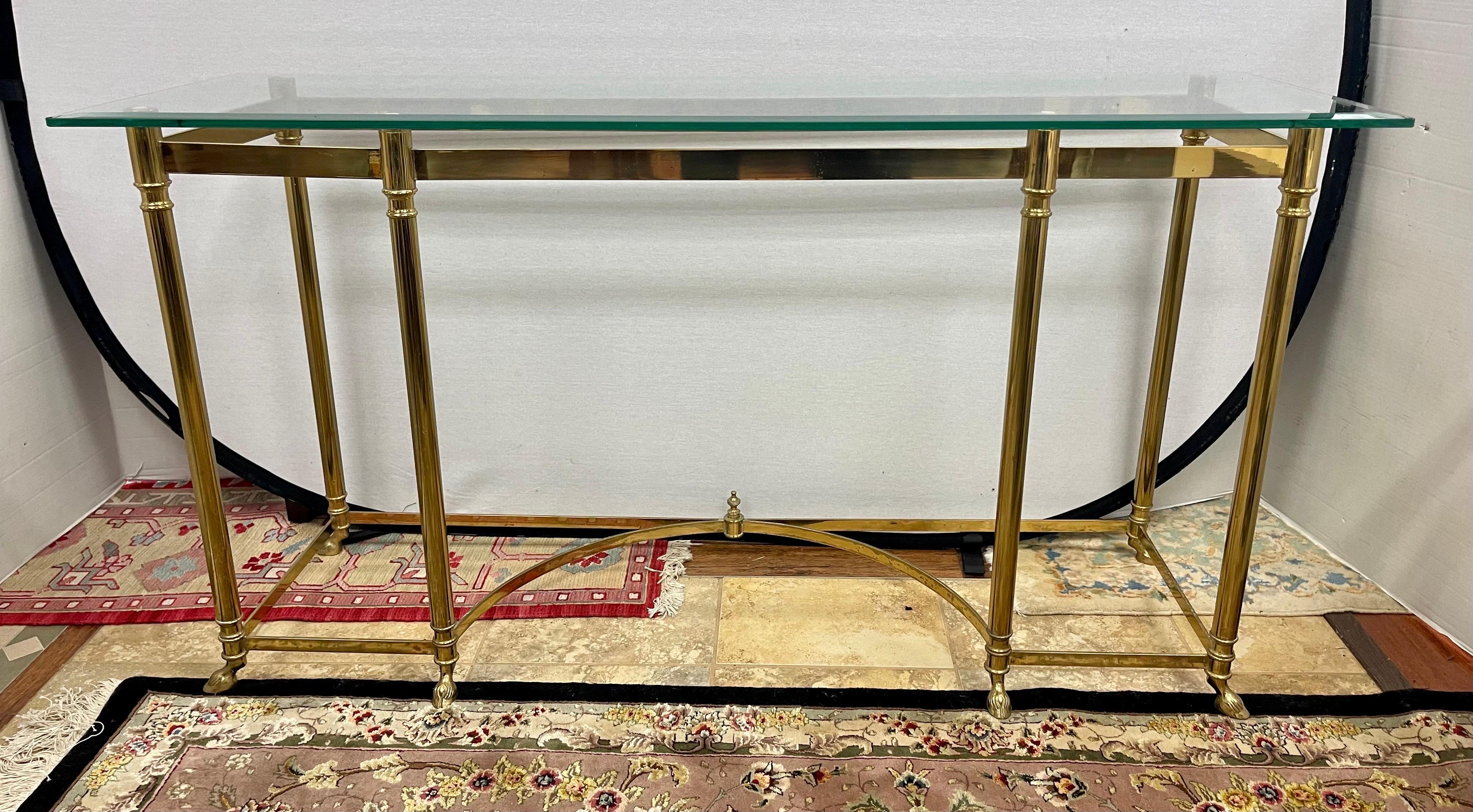 Elegant, vintage Maison Jansen brass and glass console table that measures a robust 56