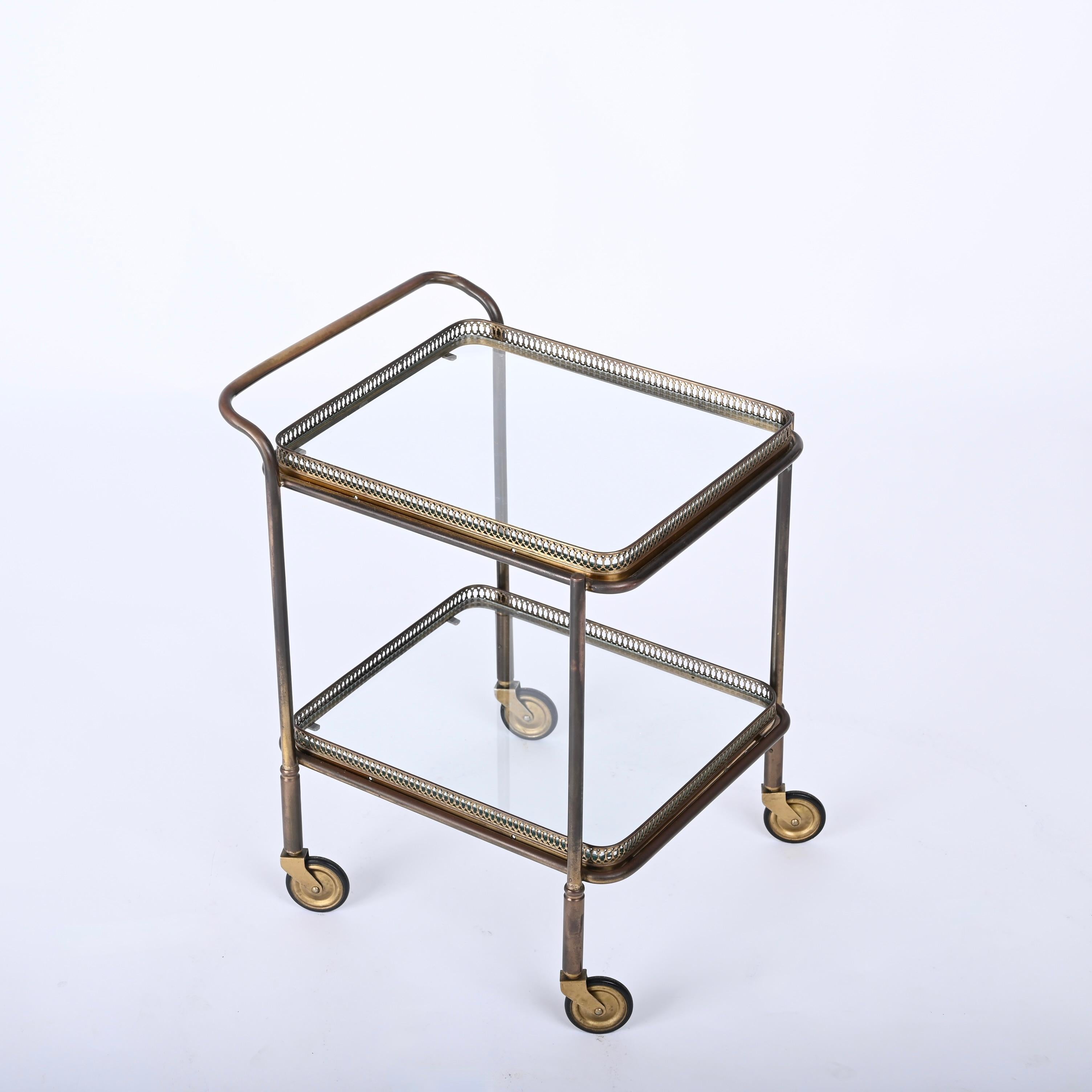 Magnificent midcentury brass and crystal glass rectangular serving bar cart. Maison Jansen produced this cosy serving trolley in France during the 1950s .

This item has wonderful shelves of this unique piece are made of carved brass with stunning