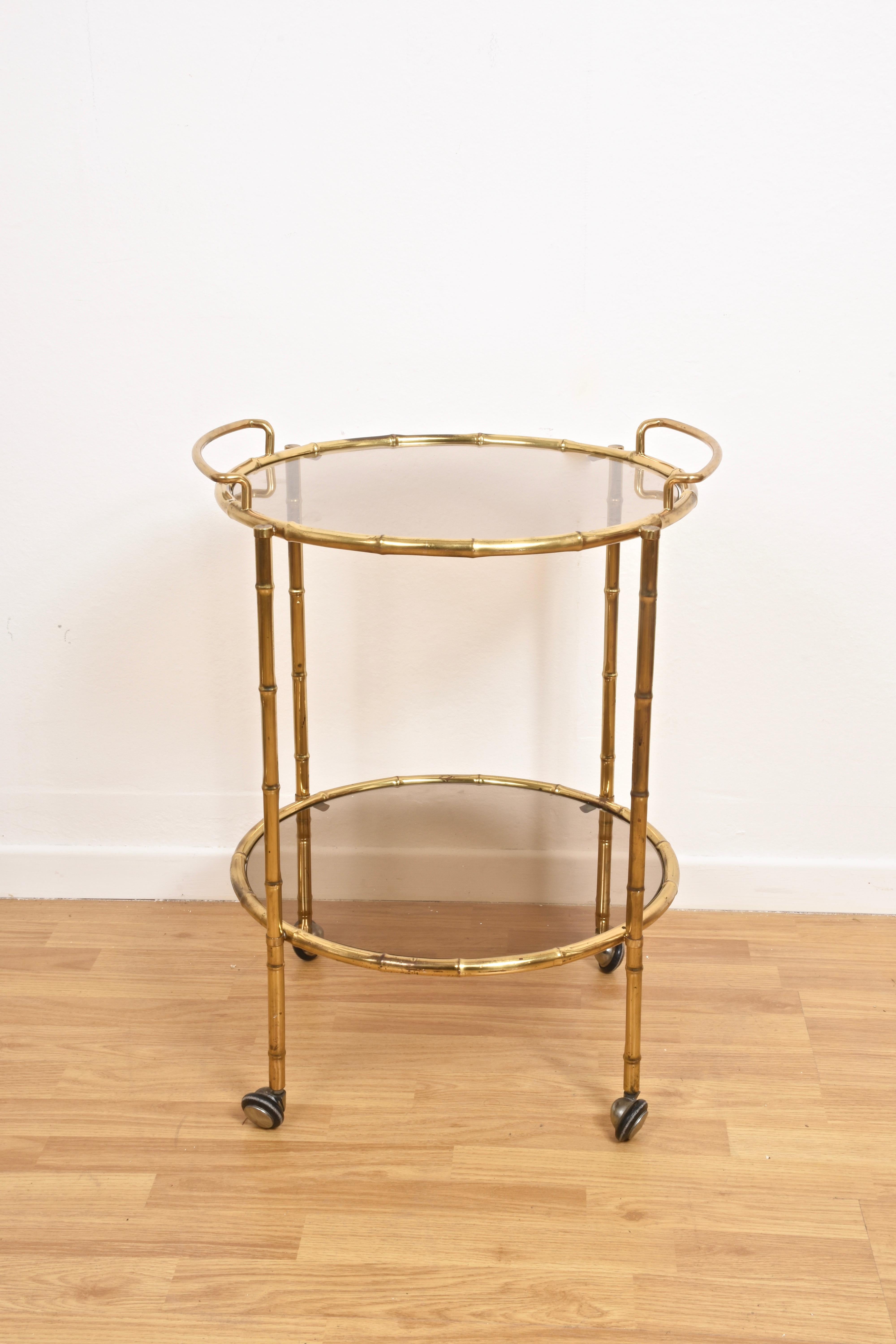 Magnificent midcentury brass faux bamboo serving bar cart. This serving trolley was produced by Maison Jansen in France during 1970s.

This piece is unique as the structure is made in brass shaped like bamboo (faux bamboo). This amazing piece is