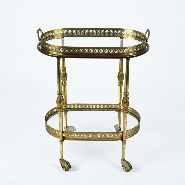 Magnificent midcentury brass serving bar cart. This serving trolley was produced by Maison Jansen in France during 1970s.

The structure of this unique piece is made in fully carved brass with stunning hand made sun decorations. This amazing cart