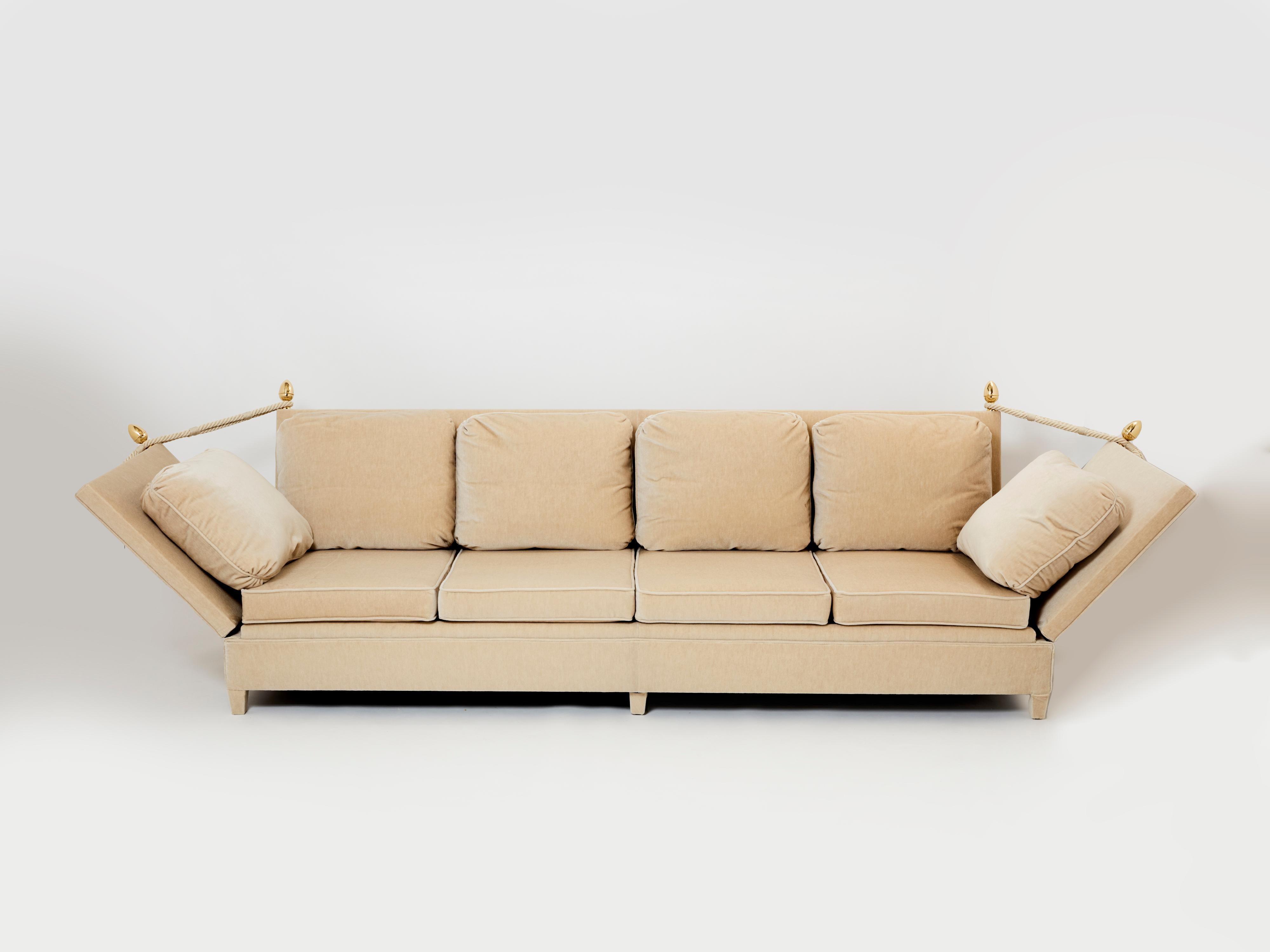Newly reupholstered in mohair velvet in a soothing sand colour, this sofa is a beautiful example of Maison Jansen neoclassicism from the 1960s and 1970s. With inventive, extendable armrests inspired from XIXth century English officers' sofas, with