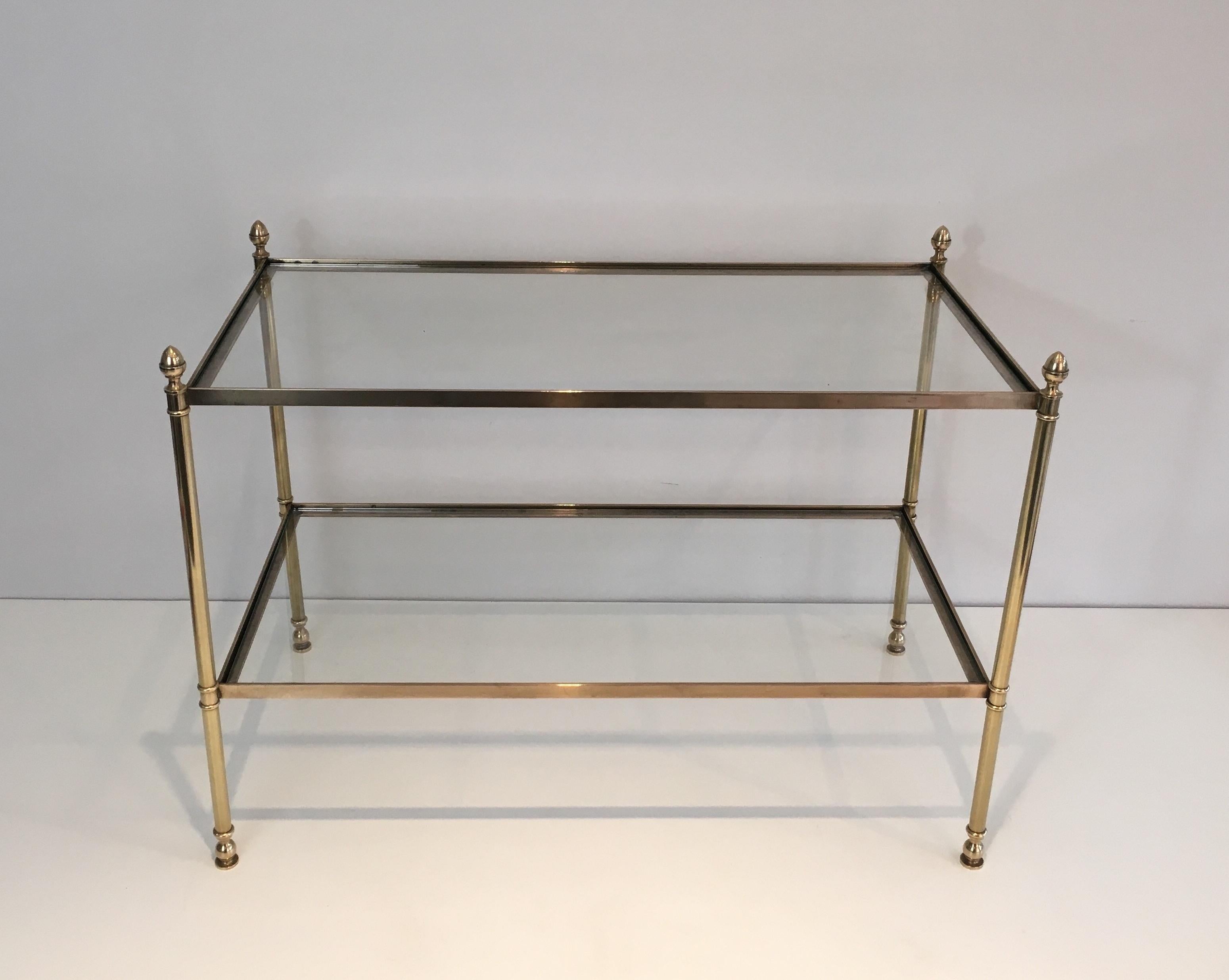 This nice neoclassical side table is made of brass with 2 glass shelves. This is a very nice work by famous French designer Maison Jansen, circa 1940.
