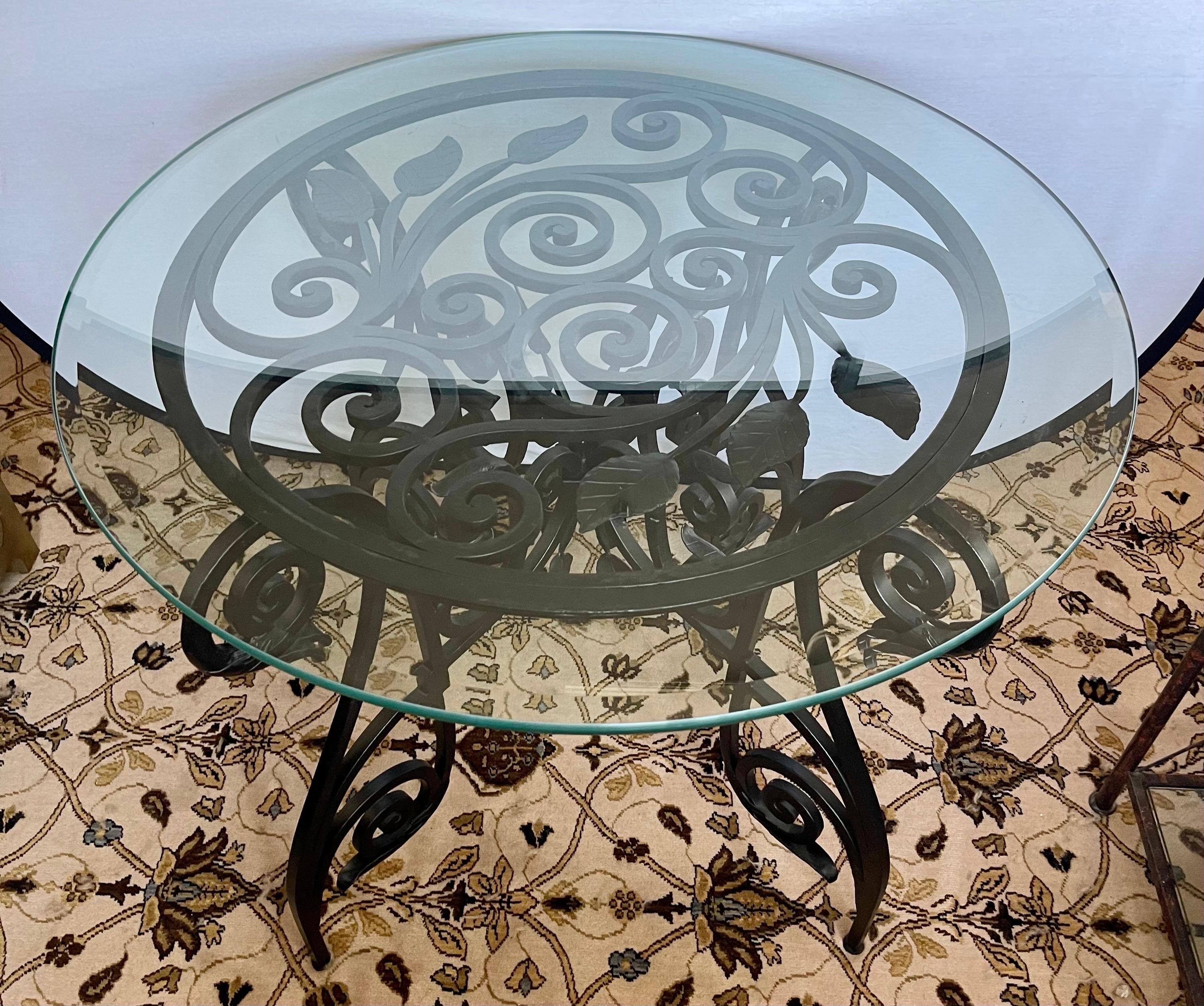 Stunning custom Maison Jansen style iron and glass center or foyer table with out of this world detail to iron sculptured base. The base alone weighs 120lbs and the glass top, which is .5 inches thick, weighs an additional 50lbs. A one of a kind