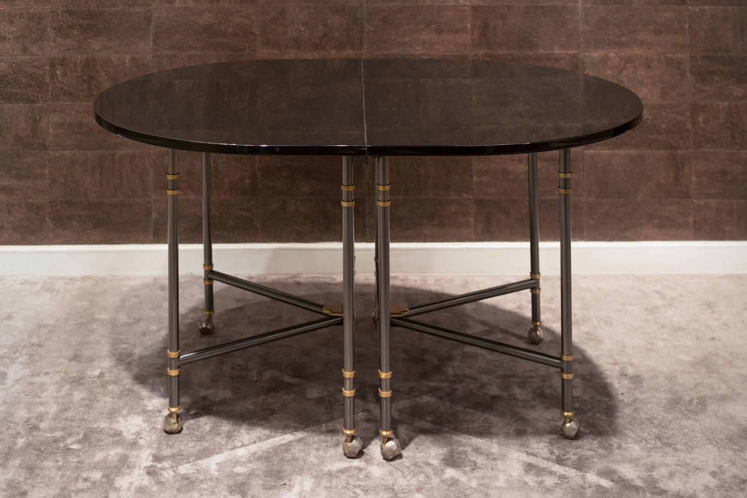 Extension oval dining table, Royale model, iconic piece from Maison Jansen France, 1960

Table with top and extension in black lacquer and details in gilded bronze and gunmetal gray metal.

Designed and made for the French actress Jacqueline