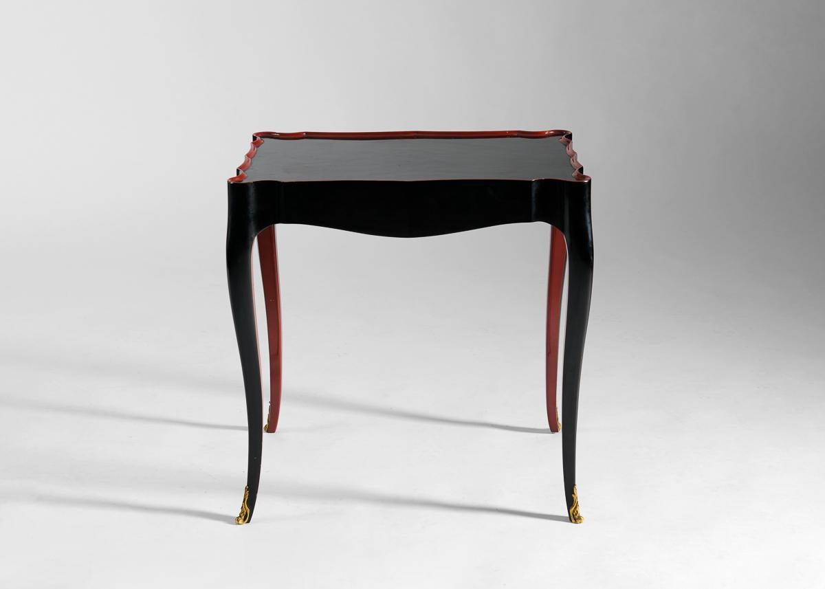 
This elegant pair of side tables with scalloped edges trimmed in coral lacquer are supported by curving legs that meet the floor with ornate, gilded sabots. Each table is stamped JANSEN and numbered 15541 and 15542 respectively.

For the better
