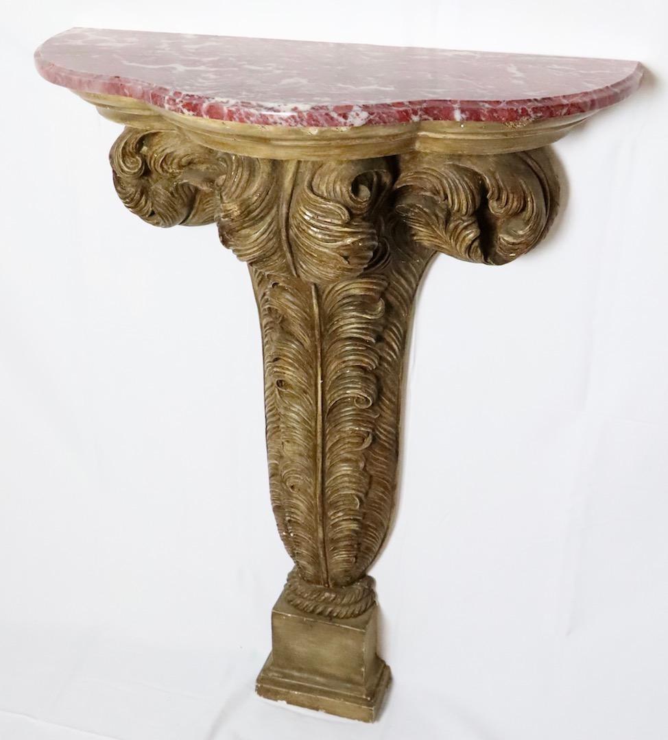 Rare pair of French wall-mounted console table tables with feather-form wood and plaster gilt bases and red marble tops. The 3-feather shape is a tribute to the Prince of Wales's heraldic badge. Very good condition consistent with age and use.
Sold