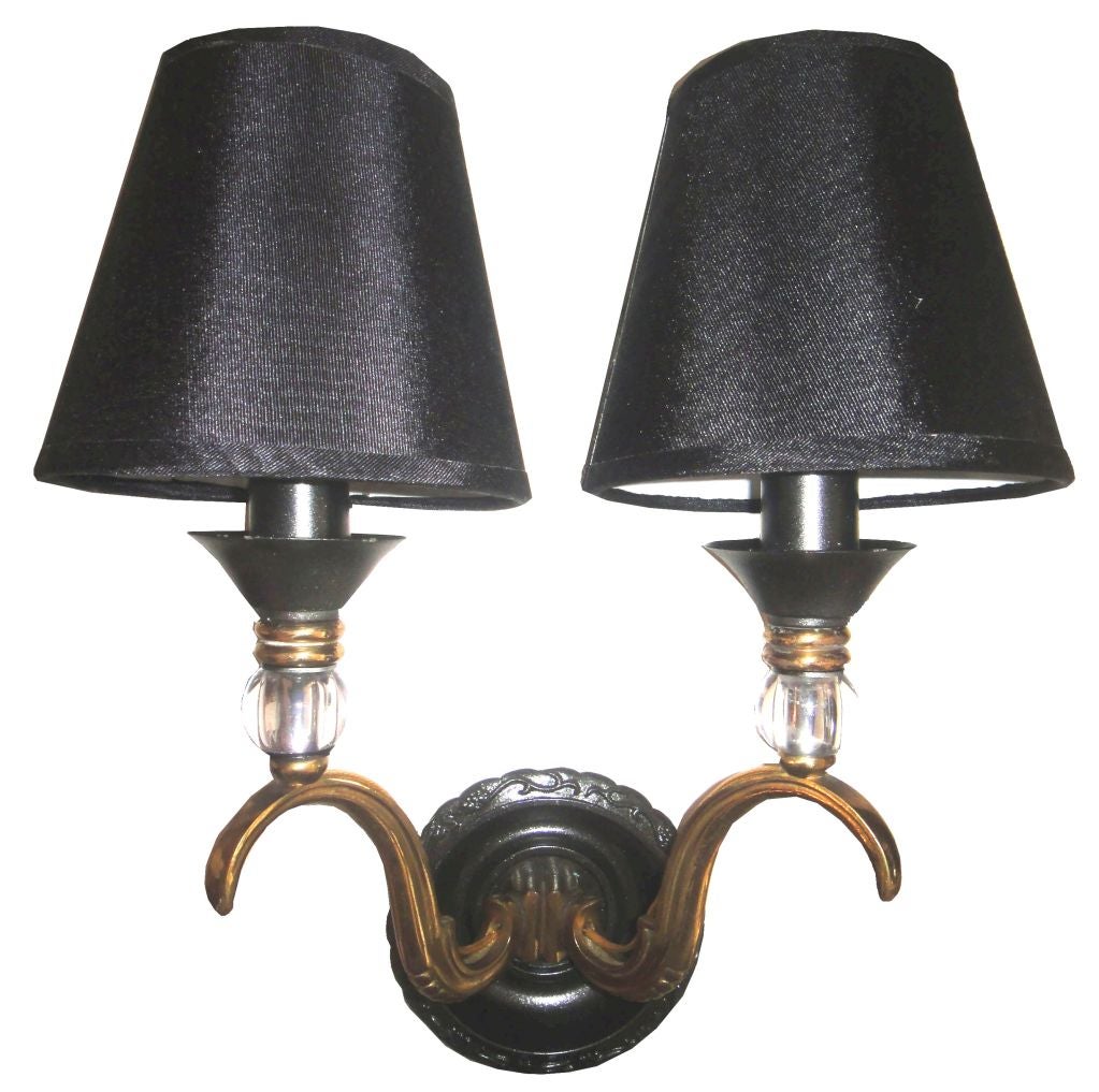Pair of sconces by Maison Jansen in two patinas brass and gun metal.
Custom larger back plate available.
Max wattage: 40 with bulb
Back plate: 4.5 inches.
Wired for US and in working condition.