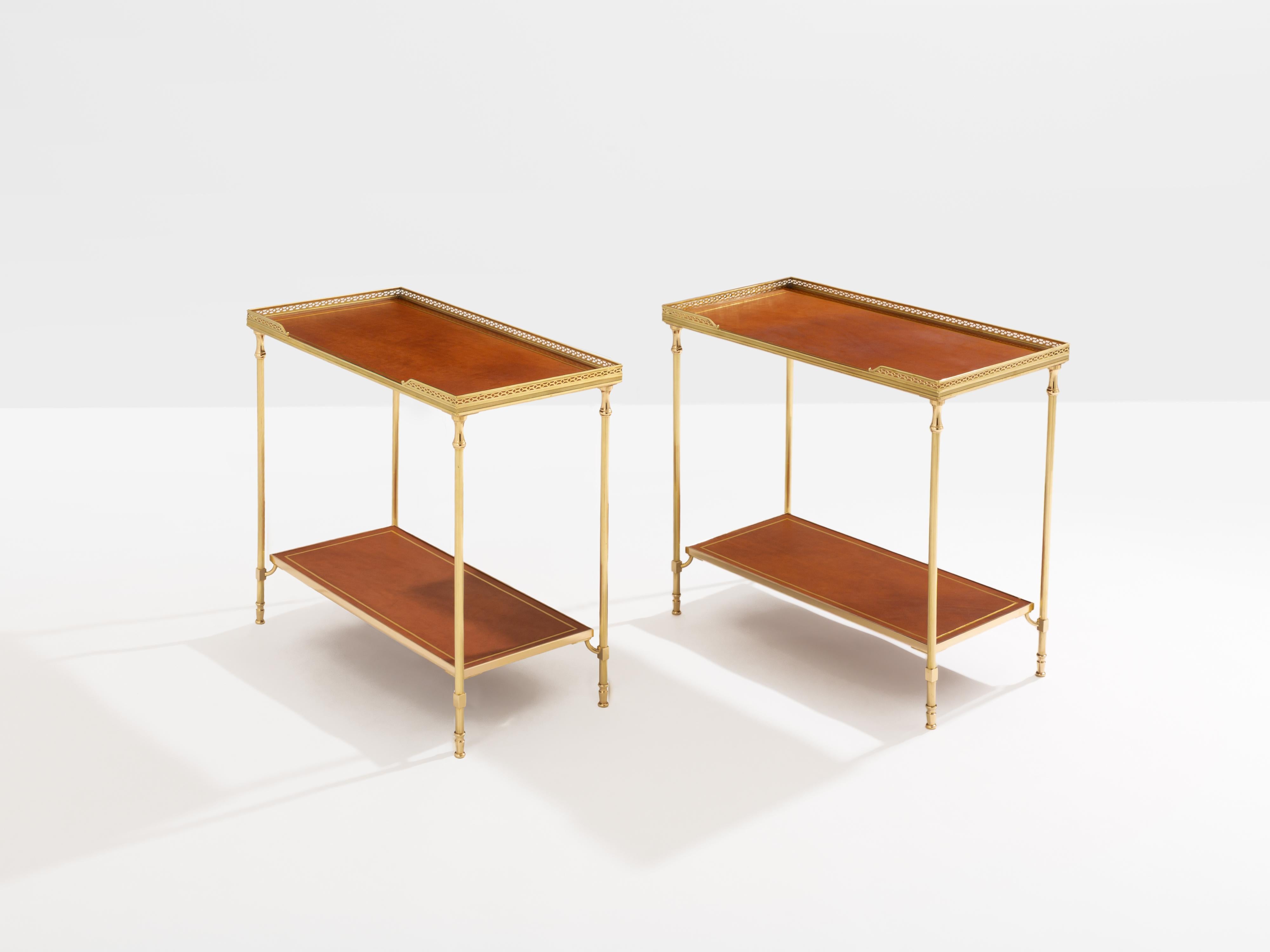 This beautiful pair of two-tier side tables by Maison Jansen was produced with solid brass and brown leather top in the early 1960s. Its brass gallery edge top, and clean lines, are typical of the French neoclassical work by Maison Jansen and offer