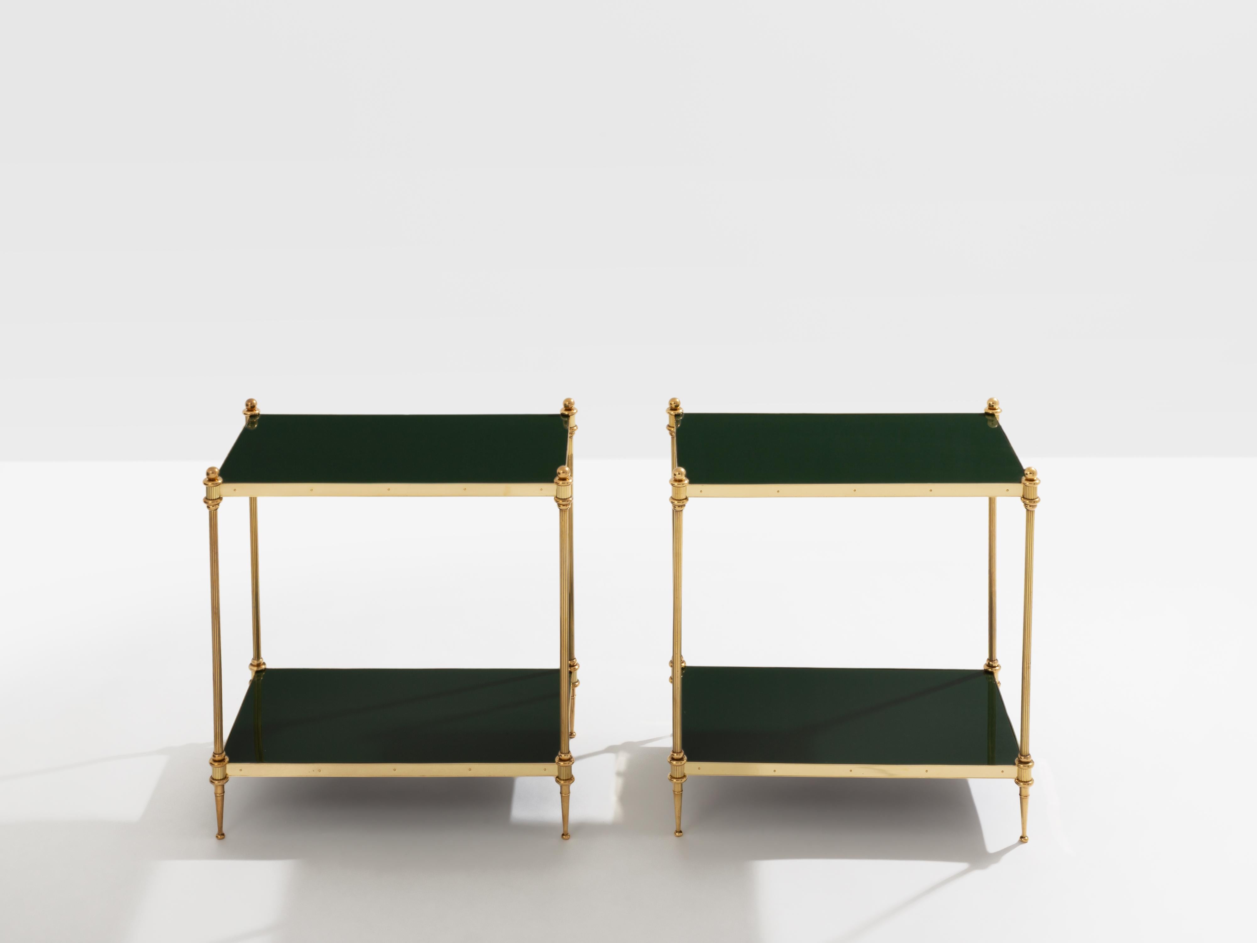 This beautiful pair of two-tier side tables by Maison Jansen was produced with solid brass and lacquered tops in the early 1970s. Its brass balls on the top, and clean lines, are typical of the French neoclassical work by Maison Jansen and offer a