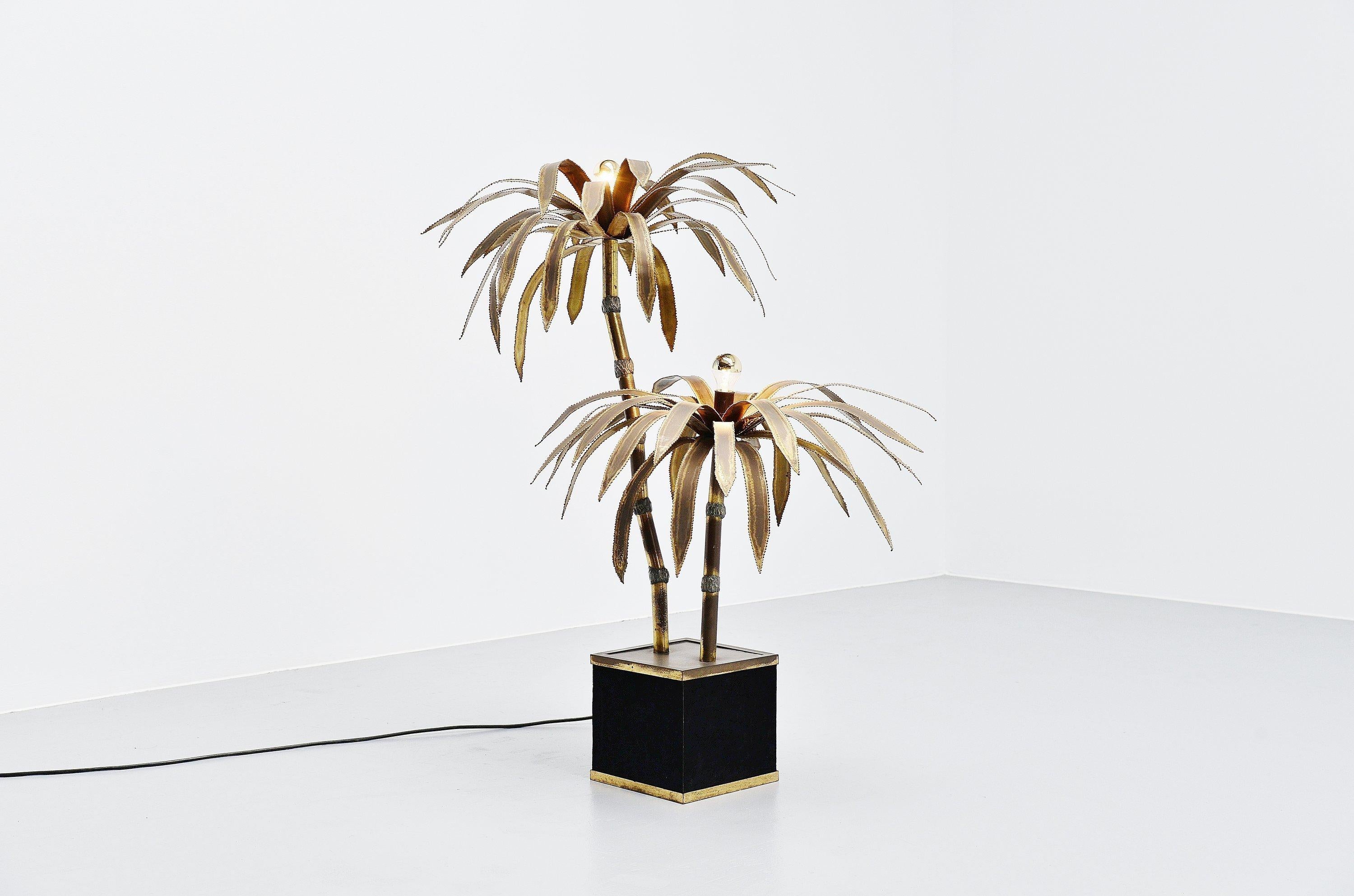 Stunning palm tree shaped floor lamp designed and manufactured by Maison Jansen, France, 1970. The floor lamp has a cubic wooden base covered with black velvet upholstery and has a brass rim. The palm is made of solid brass and has a nice patina