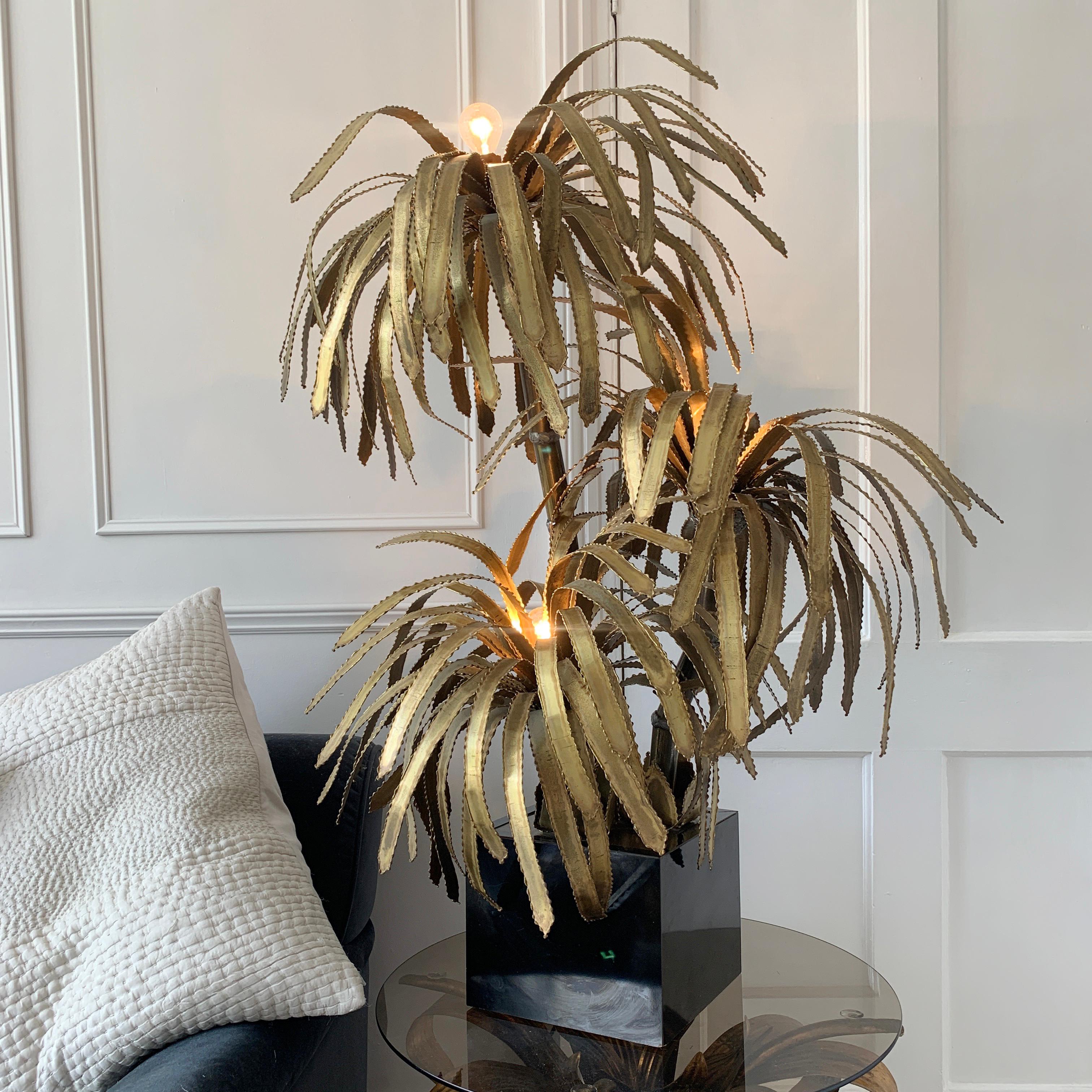 Maison Jansen brass palm tree lamp.
France, 1970s.
This is an original and unique piece, classic Maison Jansen design.
There are three main stems to the lamp with a single light fitting in each of the palm leaf tops.
The base pot is black in