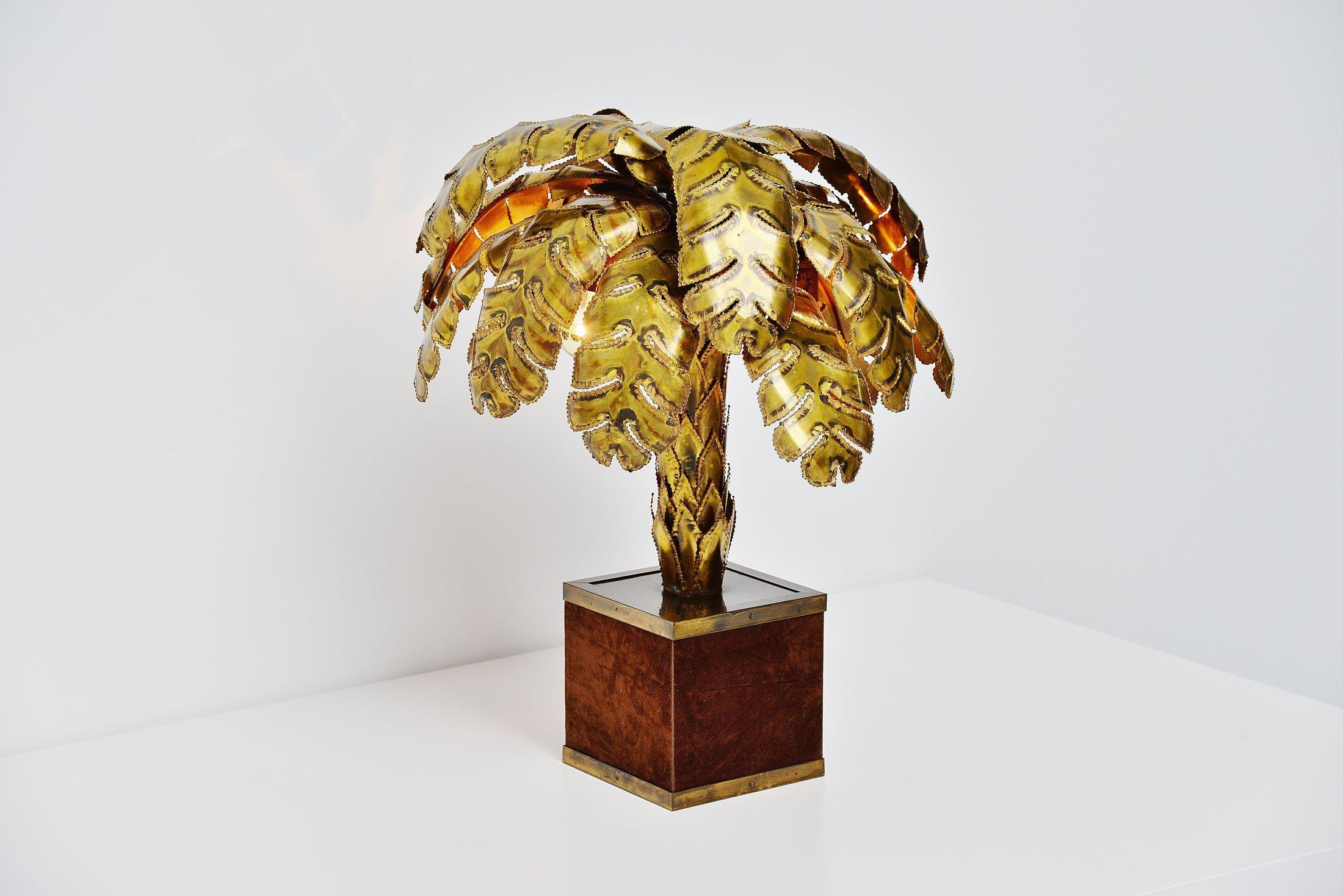 Very nice medium sized palm tree table lamp designed by Christian Techoueyres and manufactured by Maison Jansen, France, 1970. The lamp has a velvet covered brass base and the palm tree is fully made of brass details. Sculpture into a real looking