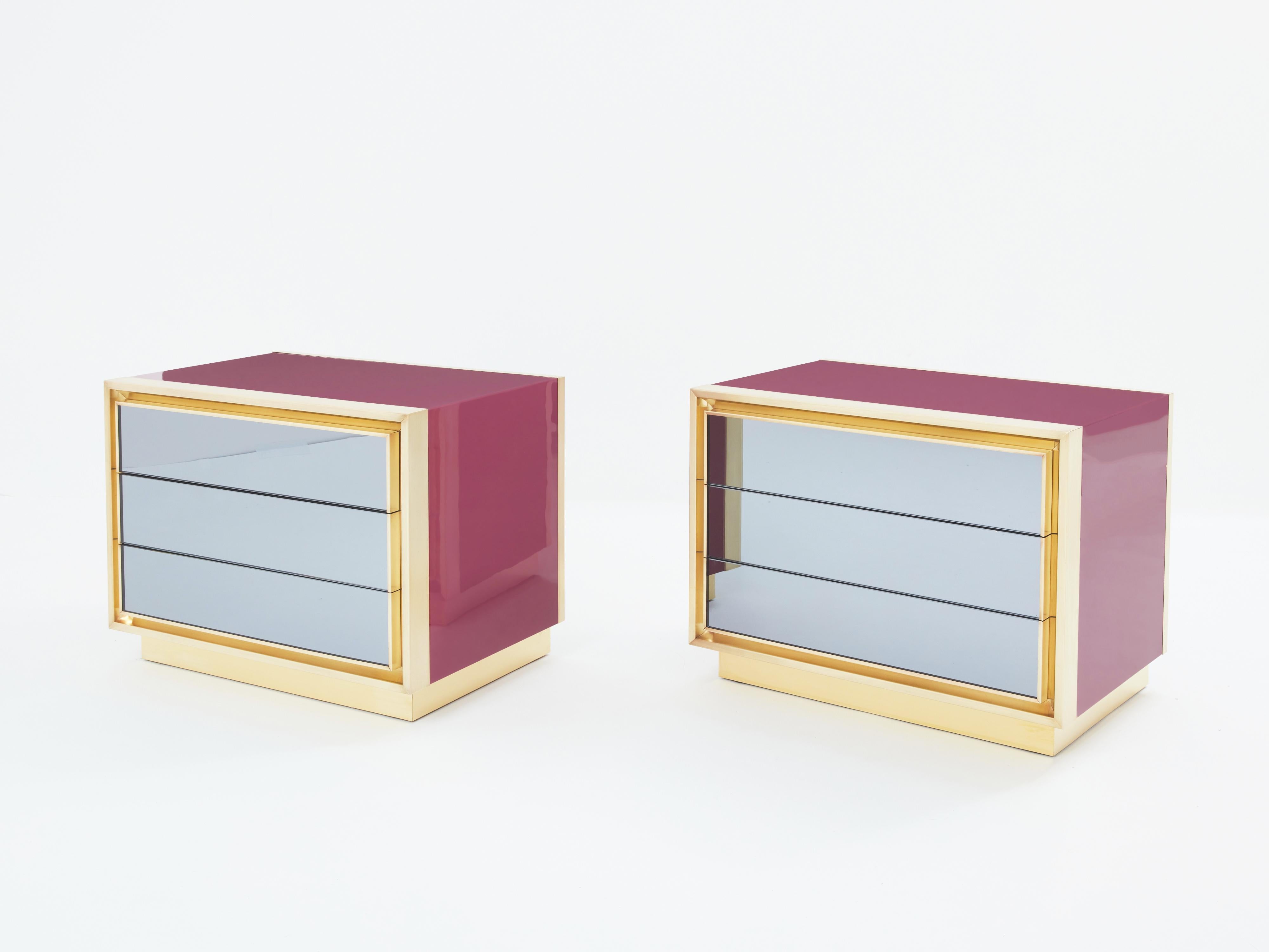 This rare pair of Maison Jasen three drawers, raspberry lacquered nightstands would be stunning in any bedroom. Made to order by Maison Jansen in France in the late 1970s, the shiny raspberry lacquer paired with brushed brass frames all around the