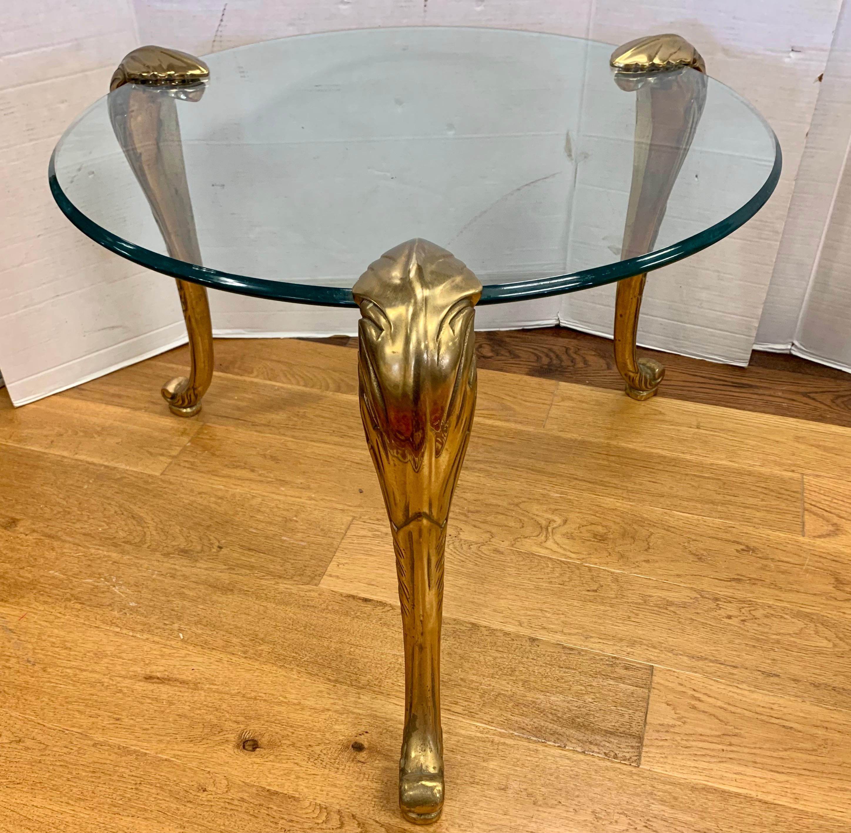 Stunning Maison Jansen 1950s end table featuring thick, original glass tops and heavy brass legs that are removable. This table is famous in design circles for a reason.