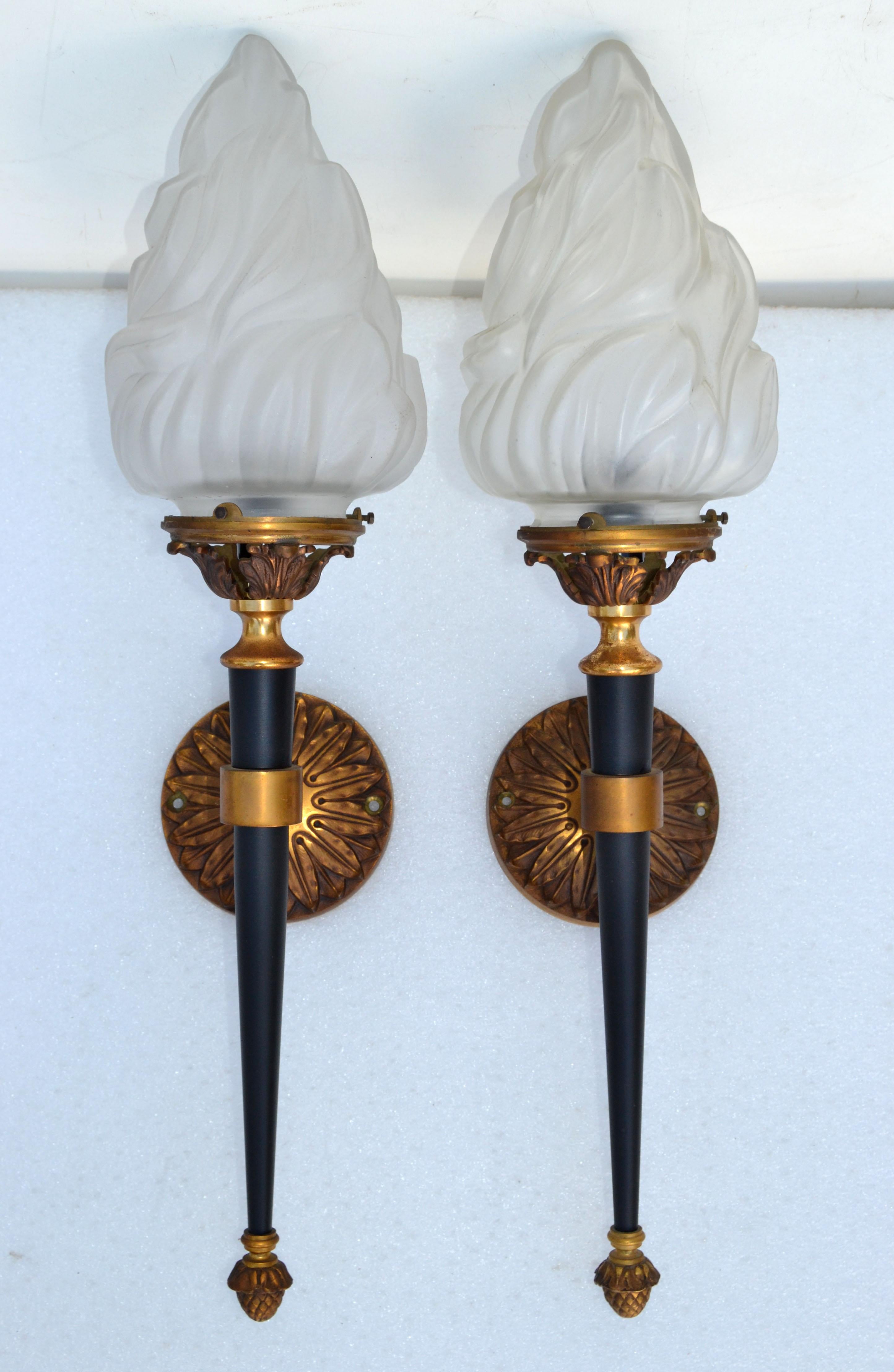 Pair of French Mid-Century Modern sconces, wall lights in solid bronze by Maison Jansen.
Featuring a torch in black finish with a blown glass flame shade. 
US wired and in working condition, takes one light bulb max. 60 watts.
Priced by pair, we