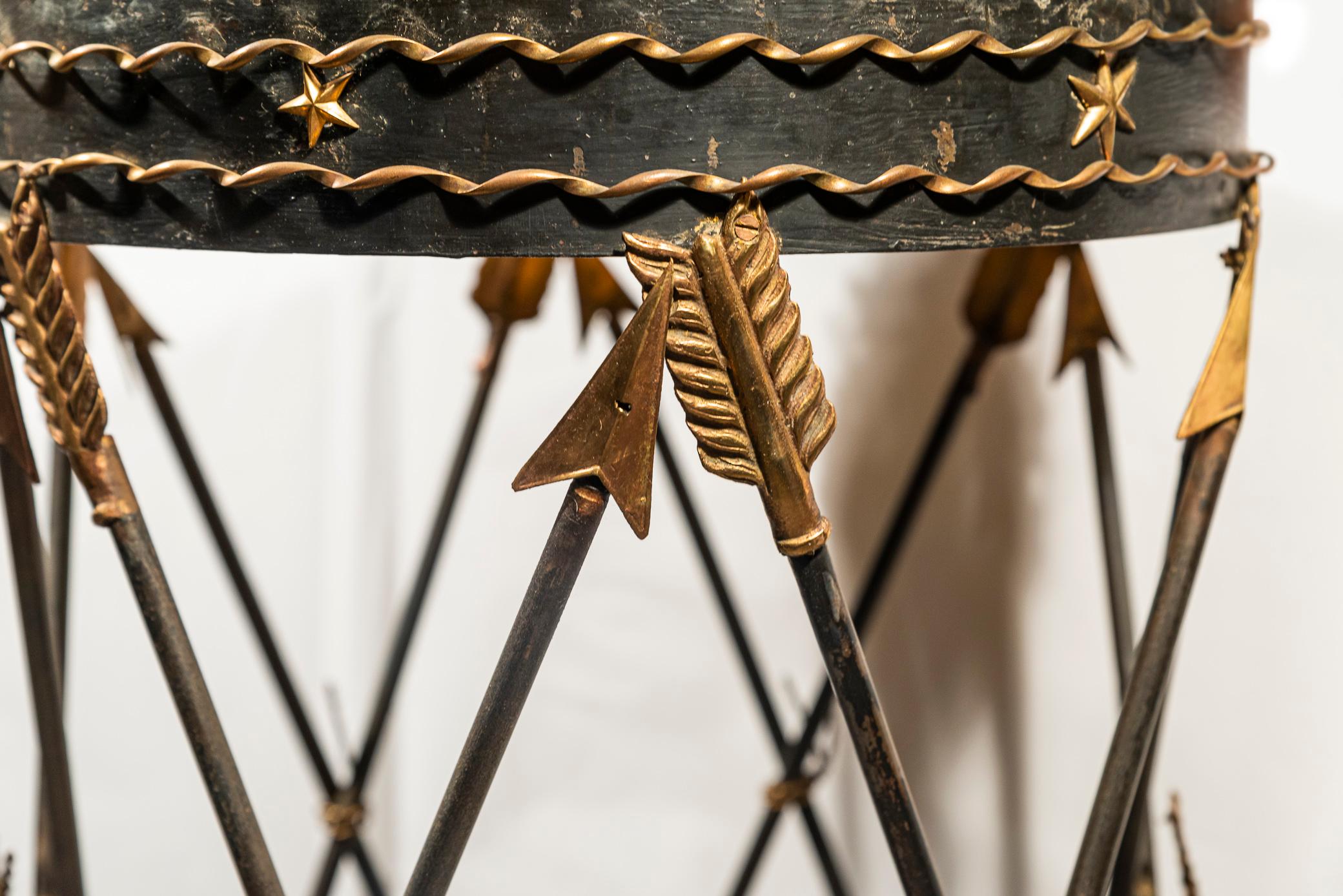 Maison Jansen,
Side table decorated with arrows and friezes of stars
Marble, iron and golden brass 
circa 1970, France.

Measures: Diameter 41 cm, height 62 cm.

Maison Jansen is an interior design house located in Paris. 
It was founded in 1880 by