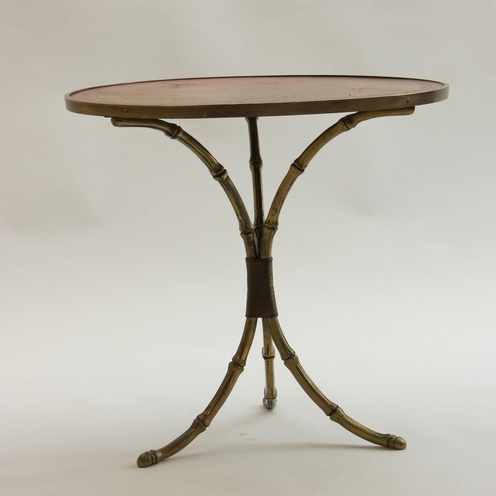 Wonderful side table by Maison Jansen, France. 
Dates from the mid 20th Century. 
Faux Bamboo base with brass edging to gilt emabossed Leather top. Very nicely distressed and patinated leather, with a wonderful rich colour. 
Very good quality,