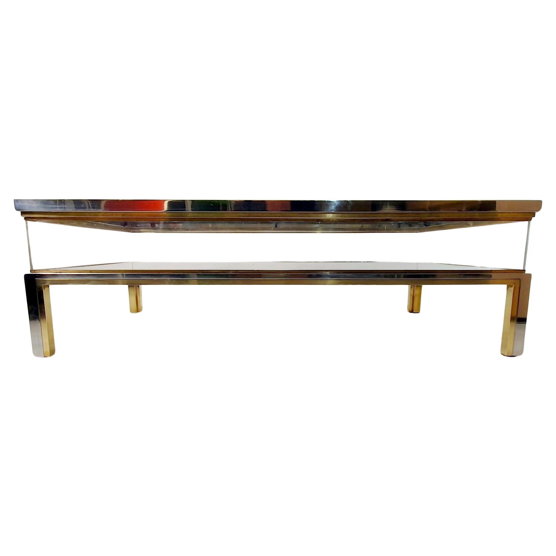 A lovely display coffee table attributed to Maison Jansen, France, circa 1970. The chrome and brass table known as a “vitrine“coffee table and it is one of the more iconic designs from the 1970'sby the famous french manufacturer. The upper level