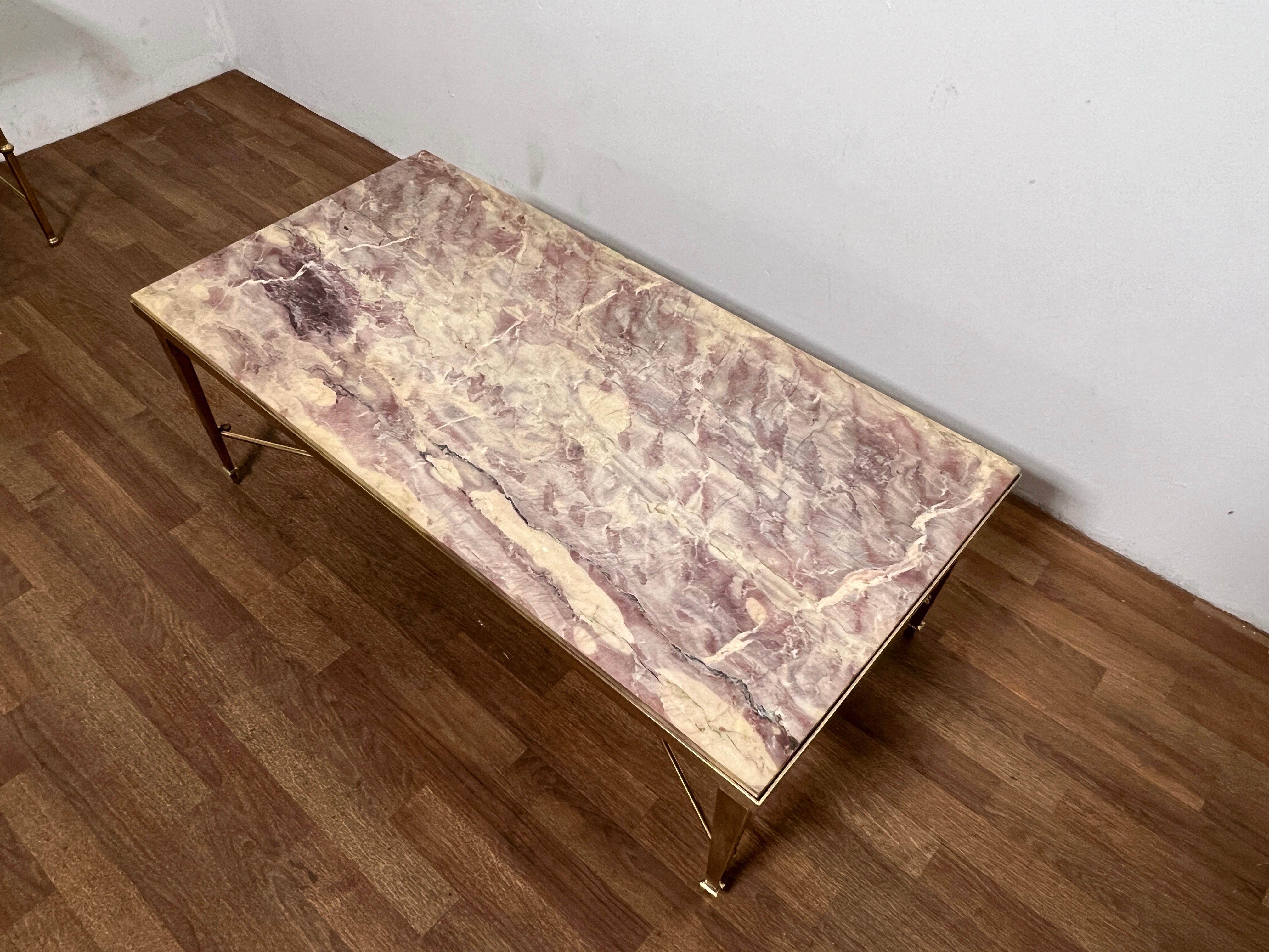 A 1950s solid brass coffee table attributed to Maison Jansen with rare lavender marble top. 
A complementing pair of side tables with matching marble from the same estate are available in another listing.