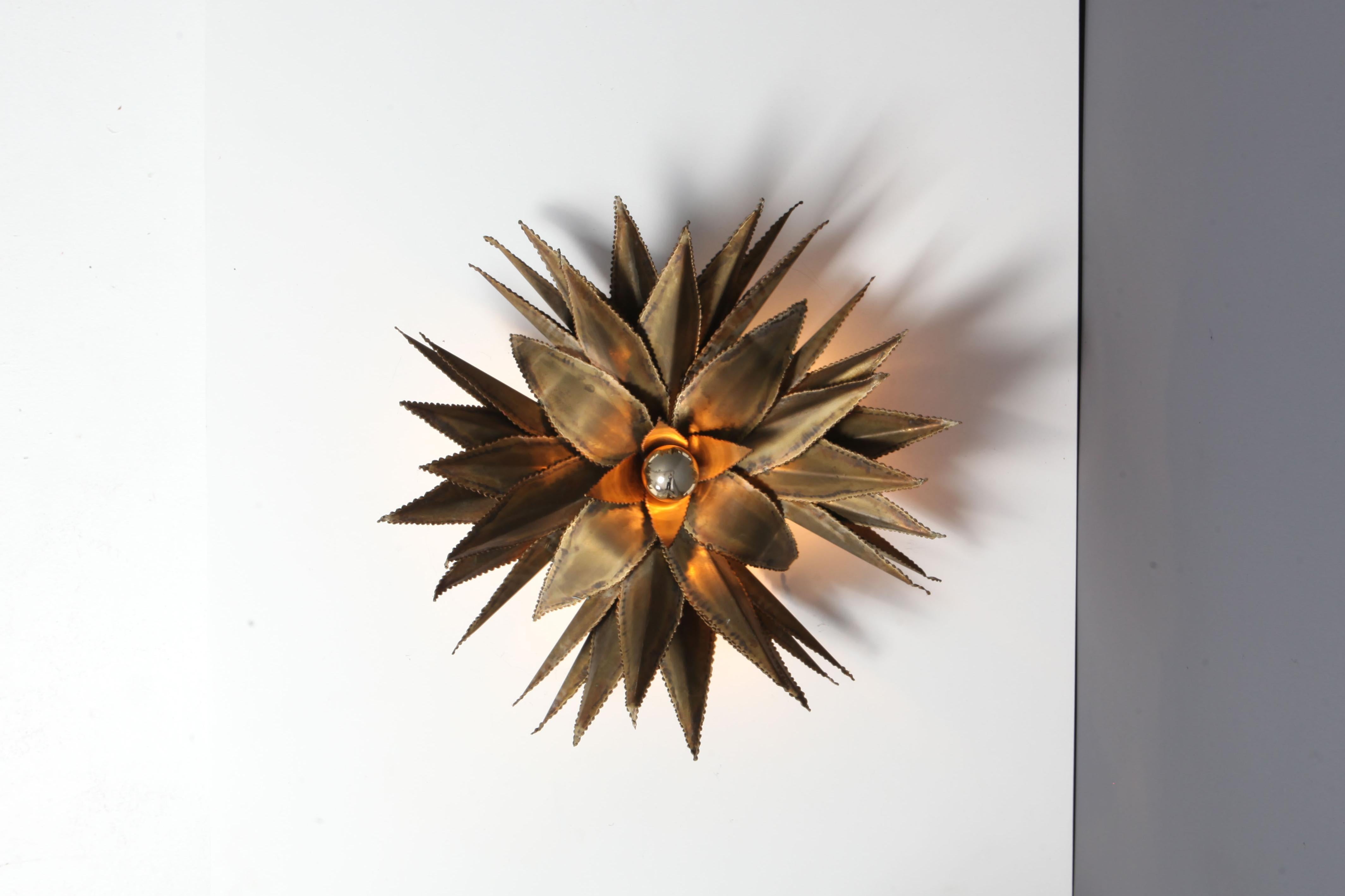 Hollywood Regency handmade fixtures by Maison Jansen, France, 1970s.
Brass star shaped palm tree wall light, custom made for a Belgian hotel in the 1970s. Priced Per piece. 

Throughout the firm's history, it employed a traditional style drawing