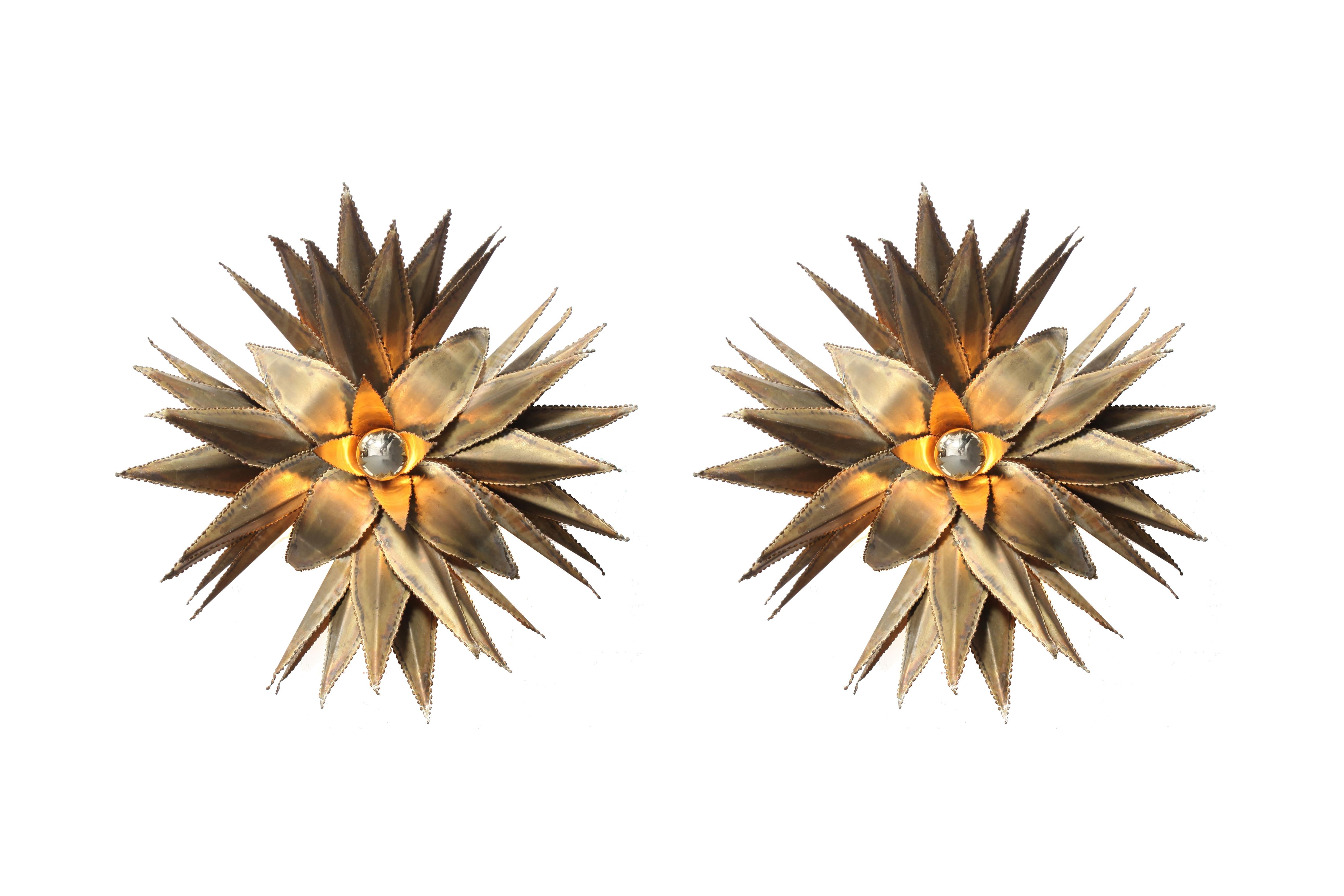 Hollywood Regency handmade fixtures by Maison Jansen, France, 1970s
Brass star shaped palm tree wall light, custom made for a Belgian hotel in the 1970s.

Throughout the firm's history, it employed a traditional style drawing upon European