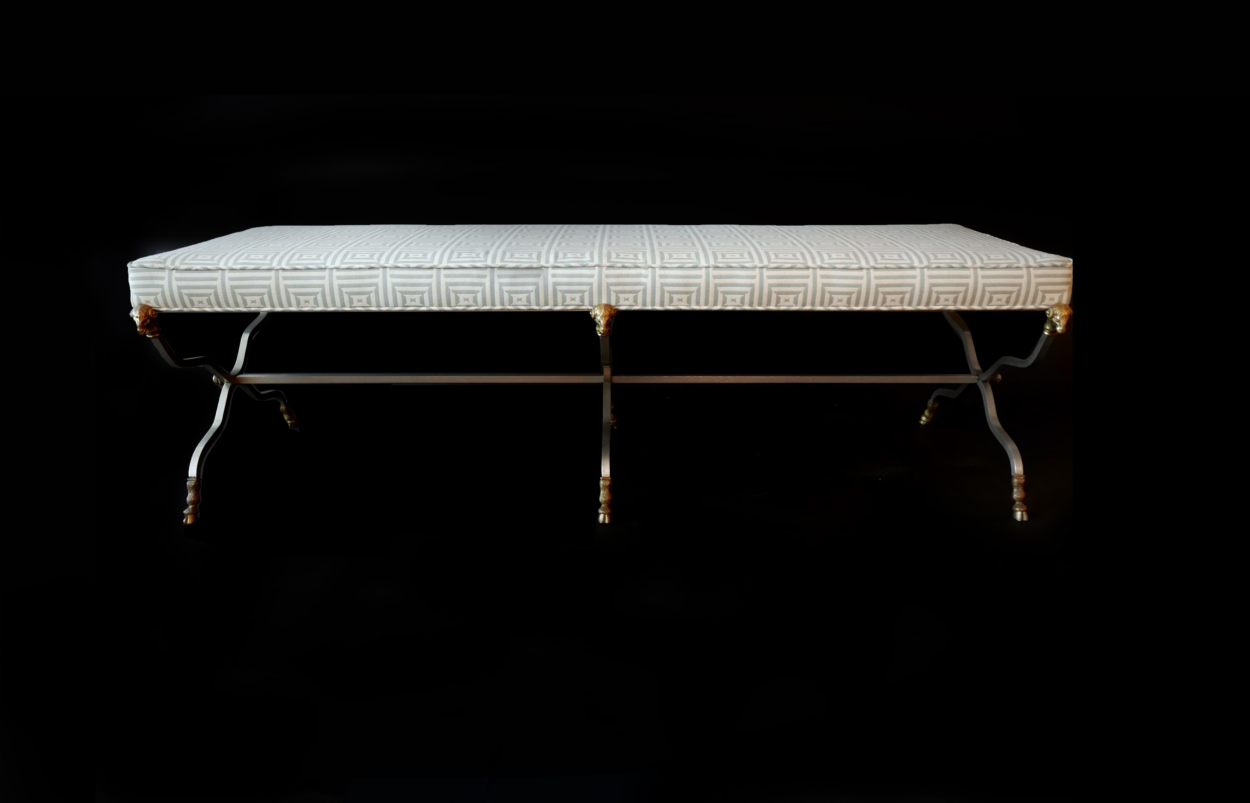 Neoclassical style steel and brass bench by Maison Jansen. The upholstered seat over a modified 