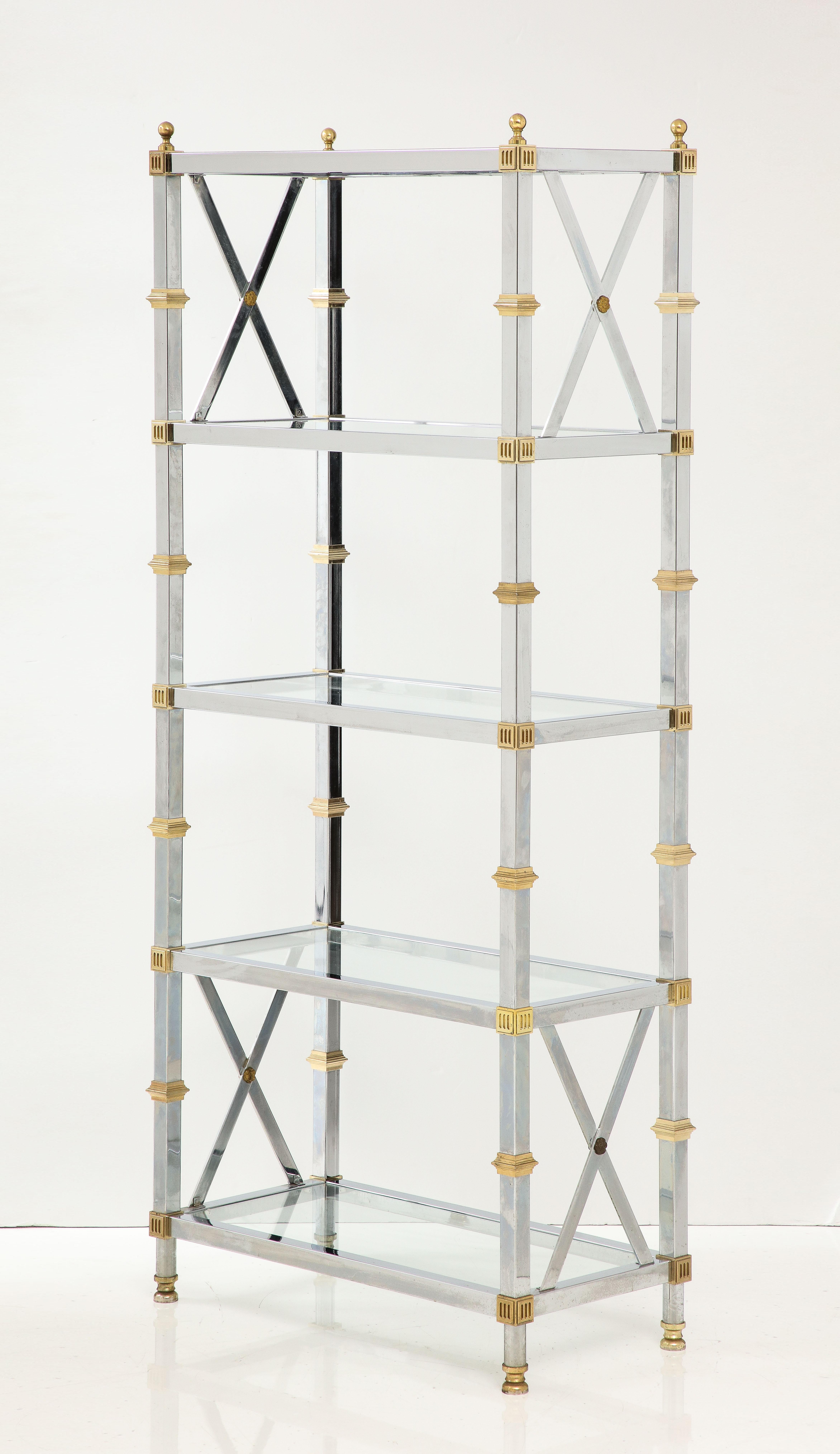 Hollywood Regency style Etagere featuring a chromed steel frame with solid brass accents and 5 glass shelves. Angreat addition to any living room area or bathroom.