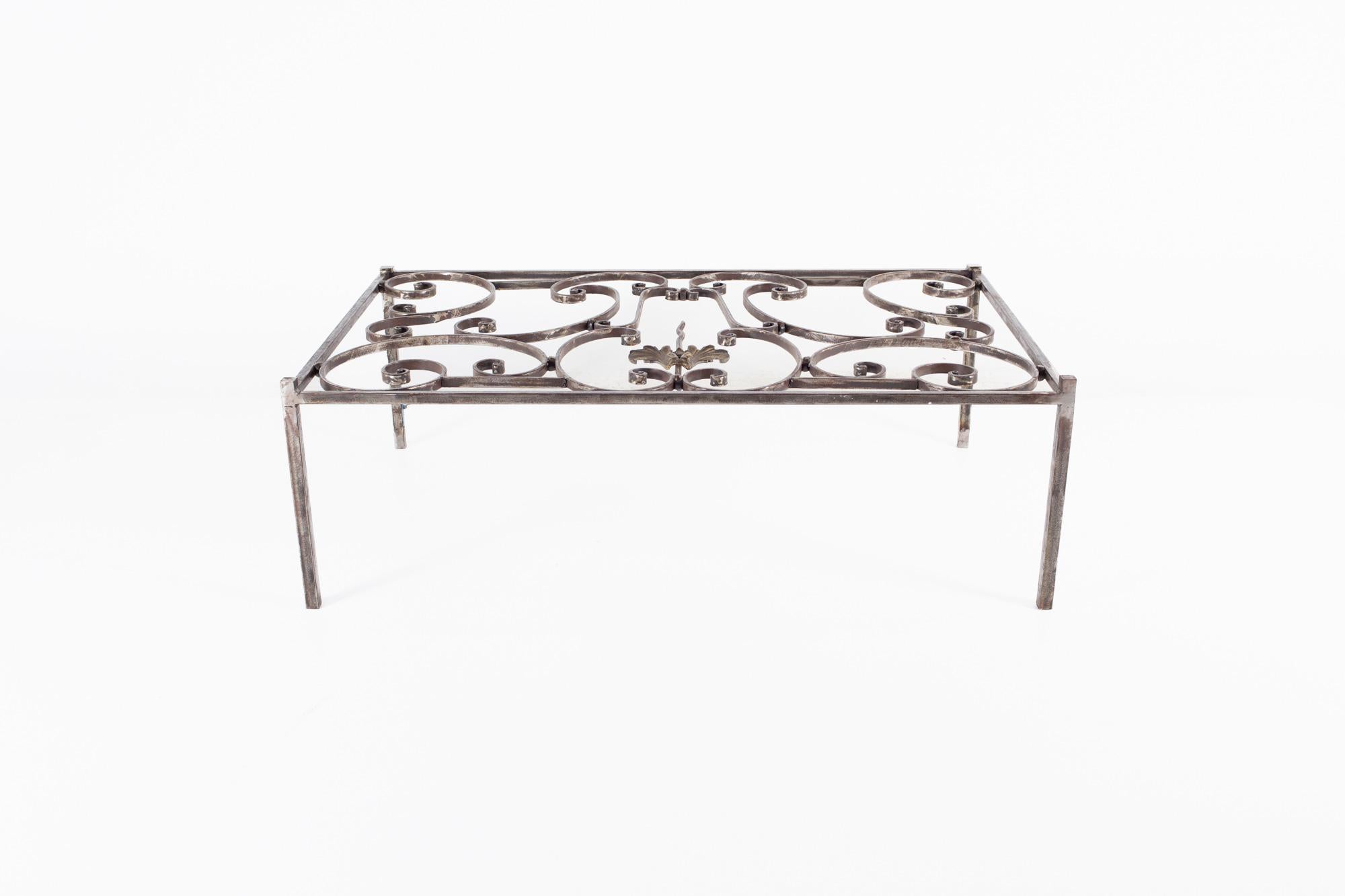 Maison Jansen style Antique French iron and glass top coffee table.

This table measures: 54 wide x 33 deep x 18 inches high.

This table is in good Vintage Condition with one brass crest loose, some oxidation on iron, minor marks, dents, and