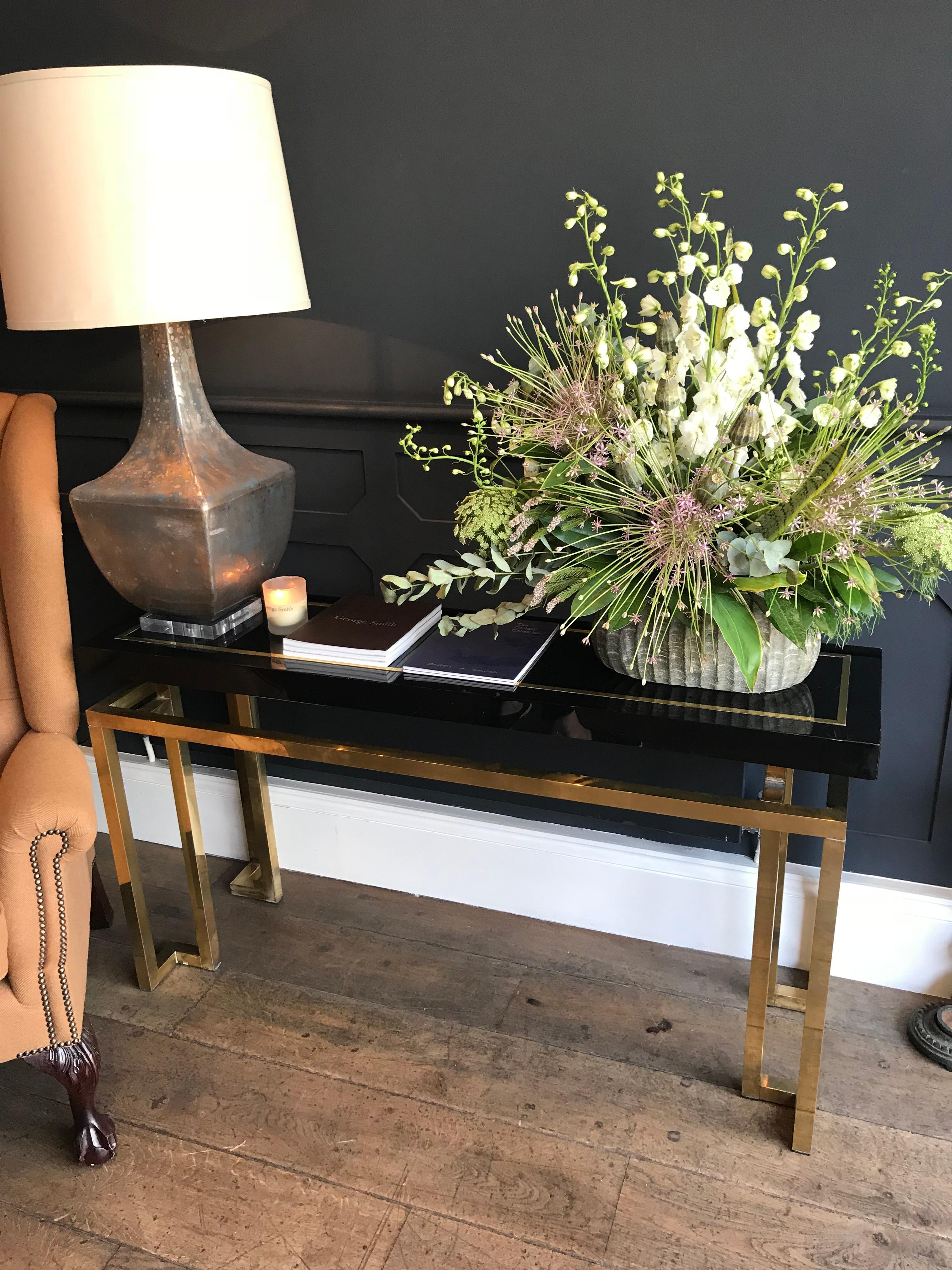 A brass and black Lucite console table with ornate brass leg design, with black Lucite top with brass inlaid detail. In the style of Guy Lefevre for Maison Jansen.
Matching mirror available too, but not included with this listing, but photos