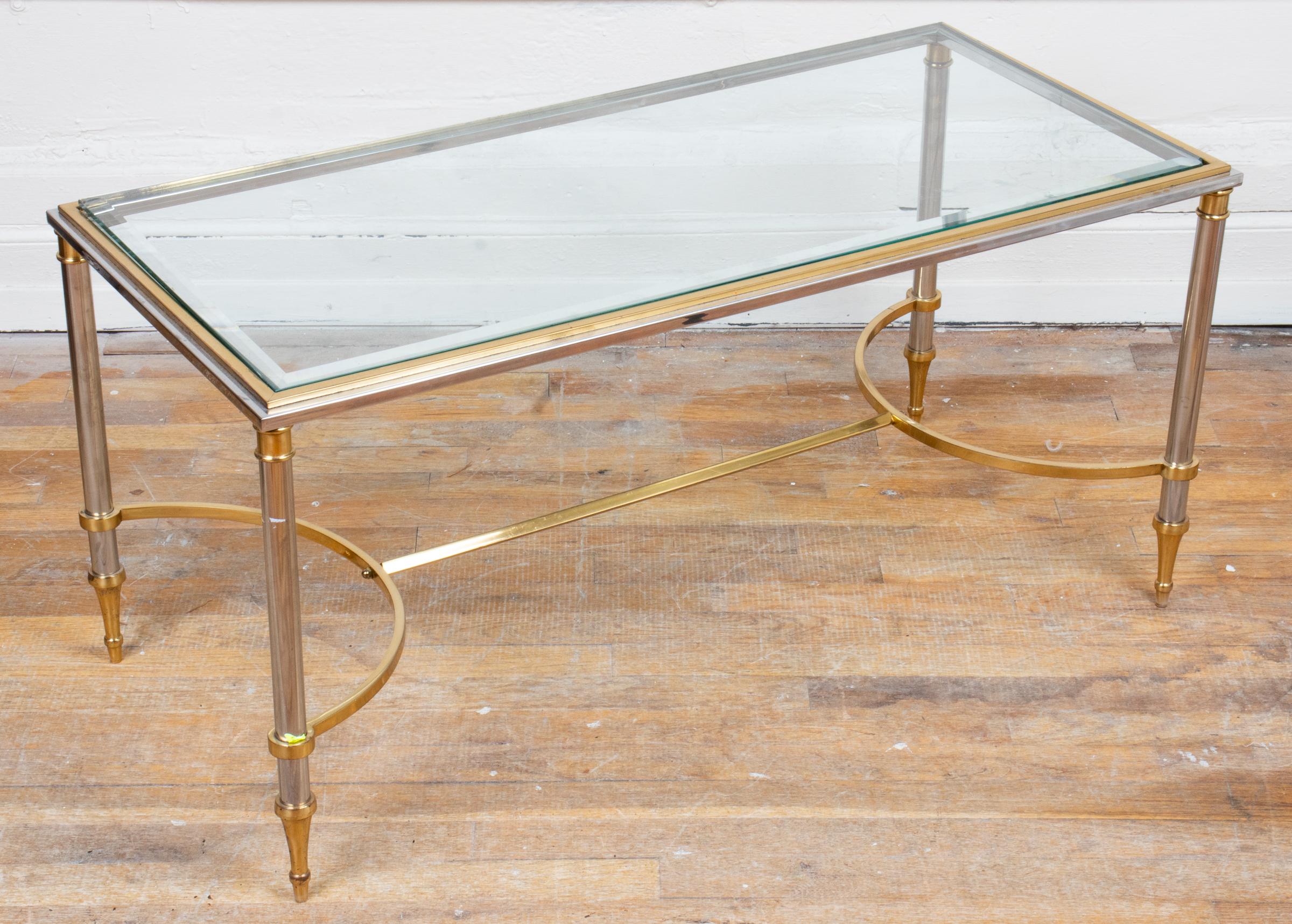 Maison Jansen style modern brass and chrome coffee table, with curved stretcher and glass top. Measures: 18.5” H x 38.5” W x 18.25” D.