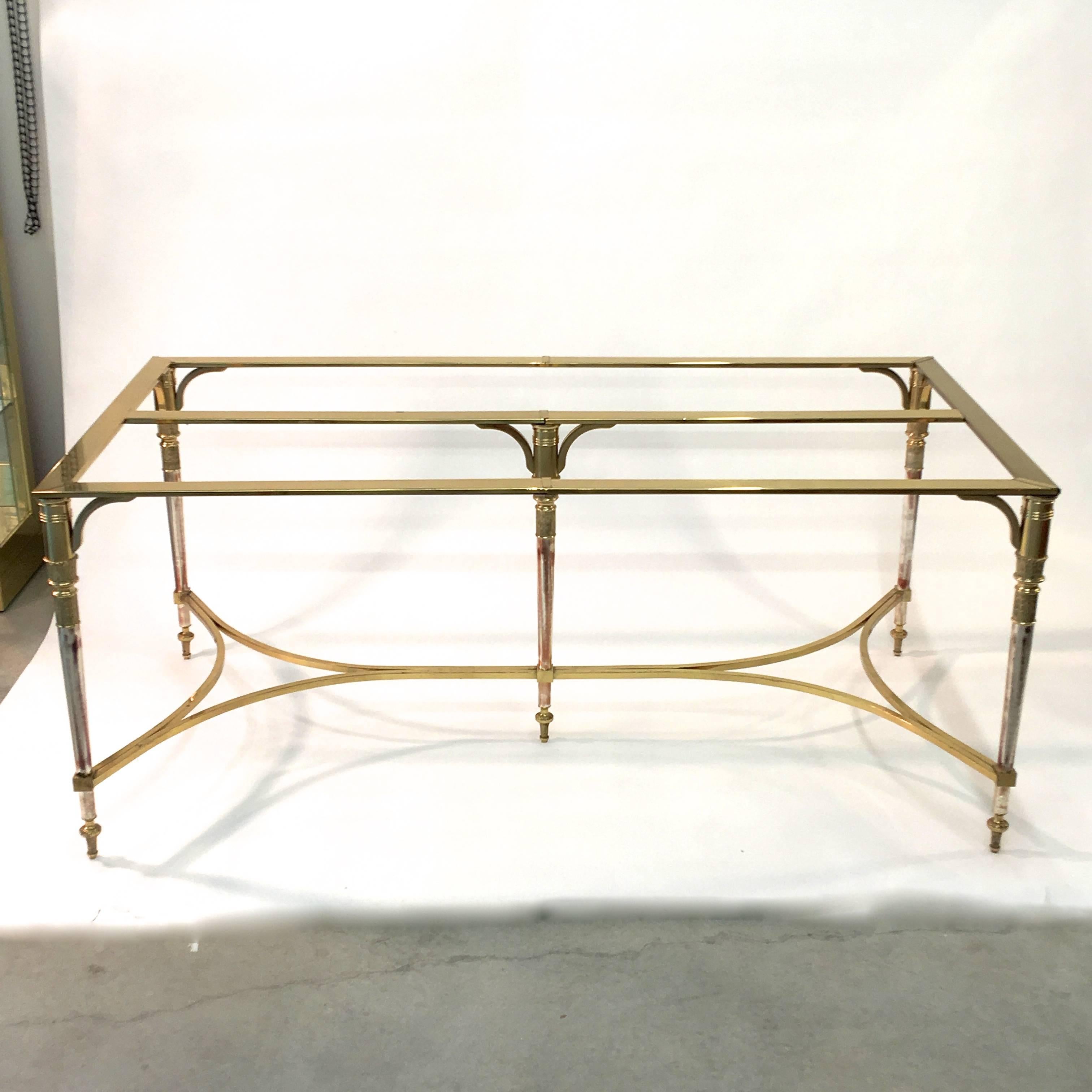 Incredibly well made neoclassical style rectangular five leg dining table made of solid brass and polished steel. The legs are tapered and are made of solid brass and polished steel. The cross stretchers are solid brass square bar. The top frame