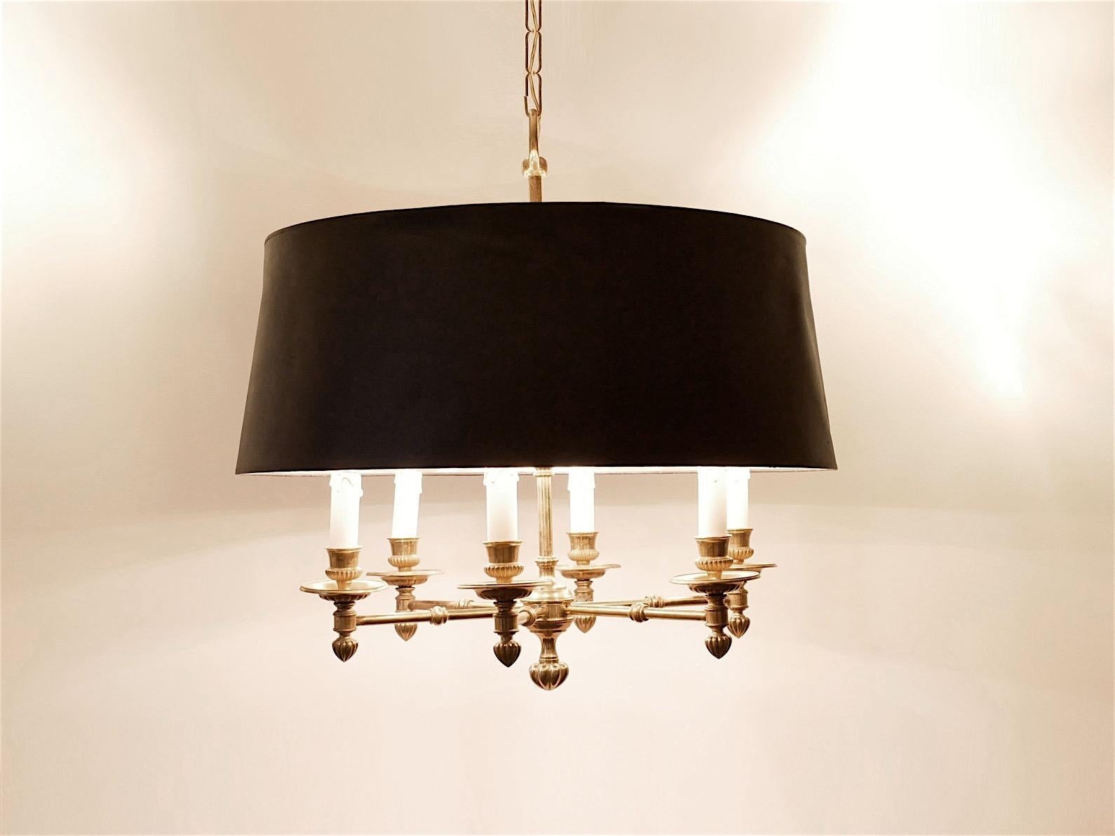 Full brass candelabra style chandelier dating from the 1940s, black textile shade with golden inner.