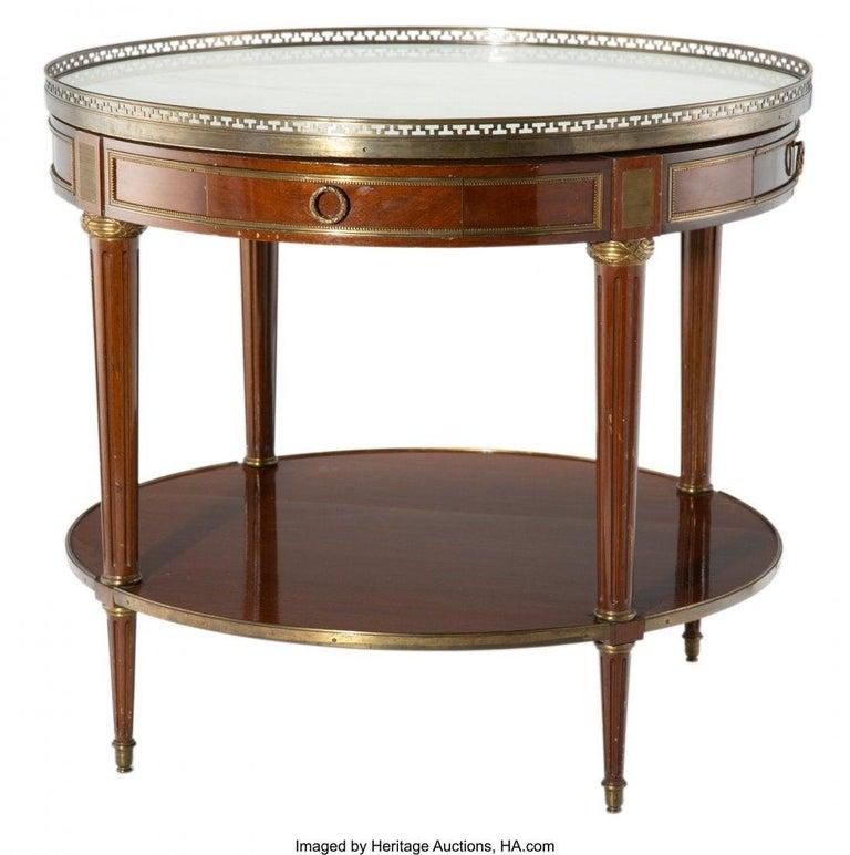Maison Jansen style center, end or card table in the Louis XVI form. The white marble-top framed in a bronze pierced gallery being pinned into the table top. The whole with drawers on all four sides and a lower bronze framed shelf area. The case