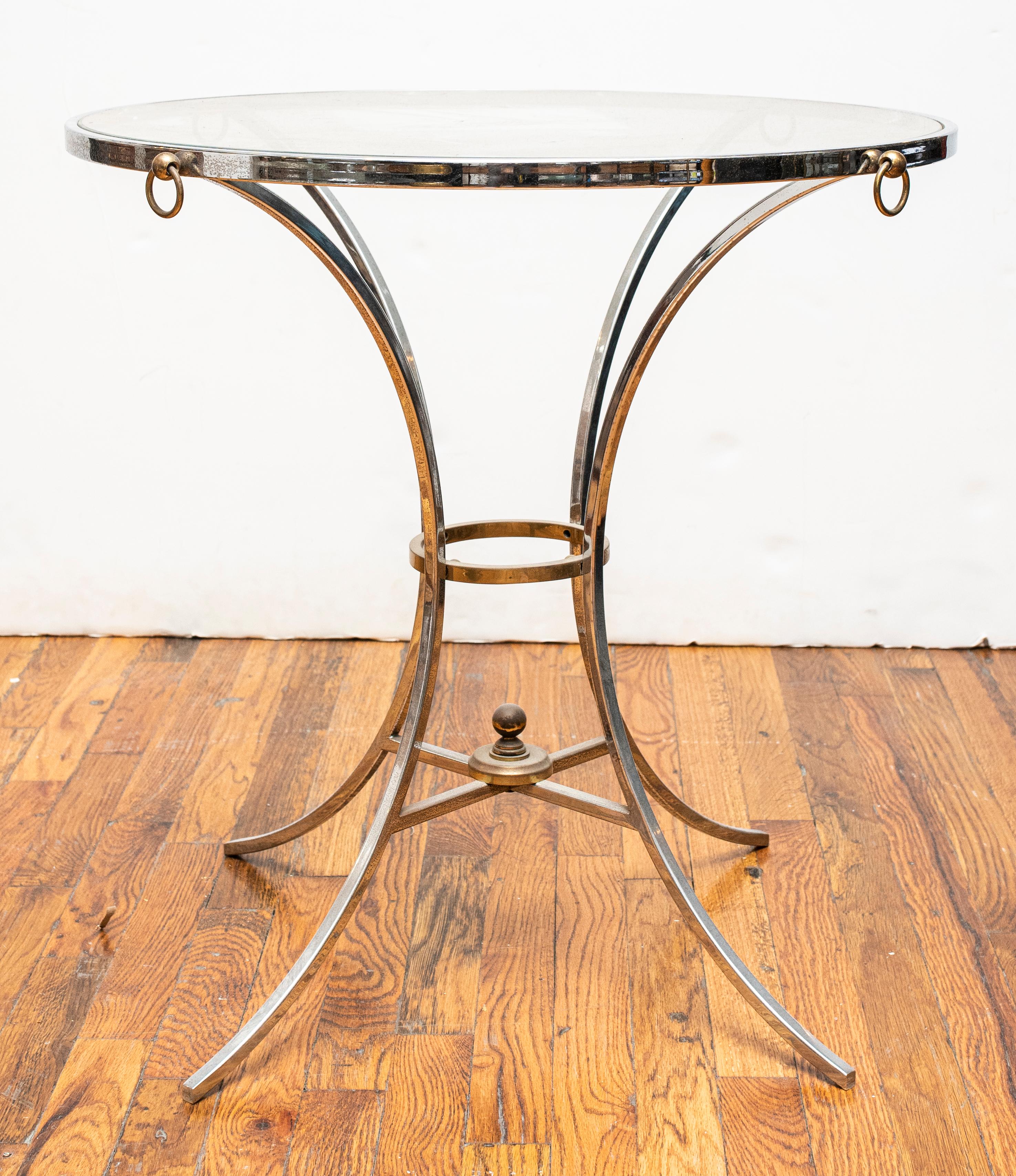 Maison Jansen style chromed metal gueridon side table with round glass top. Measures: 26.5