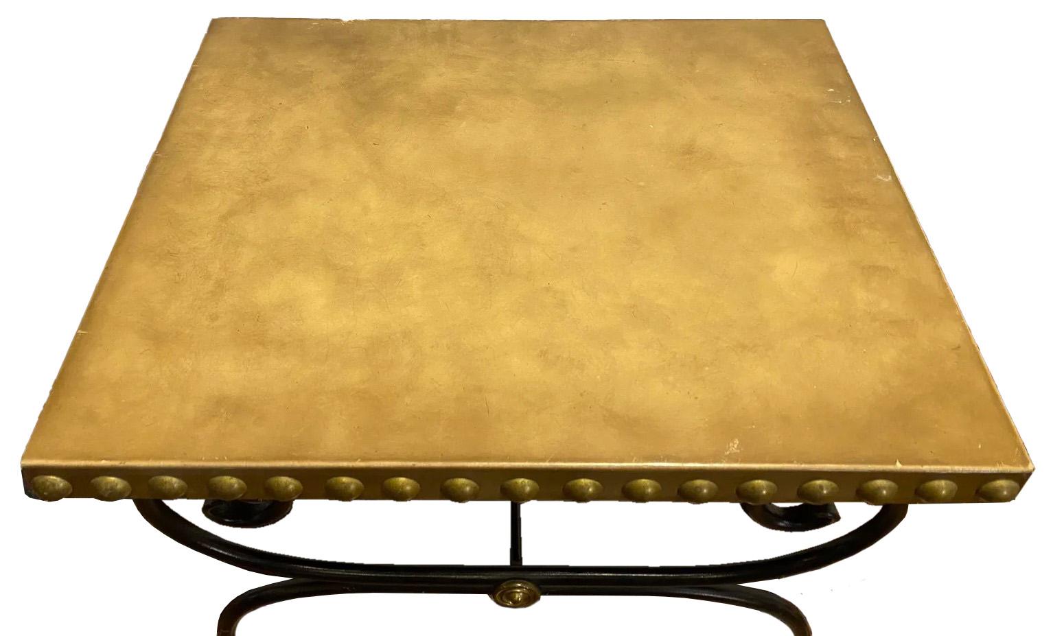 An exquisite piece that embodies the epitome of French elegance and craftsmanship - a French Maison Jansen style table. This table is a masterpiece of design, featuring a luxurious leather-wrapped tabletop that immediately catches the eye,