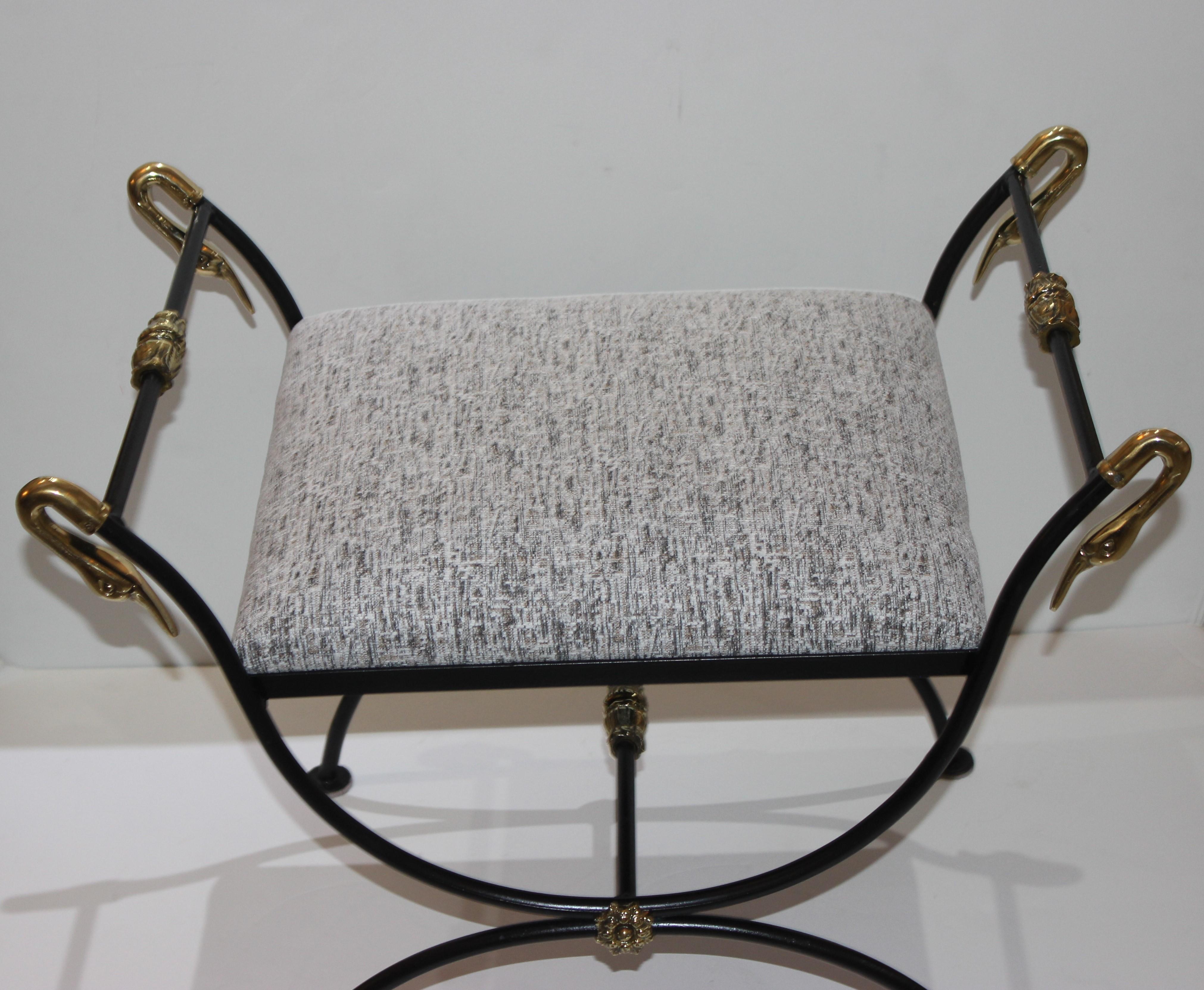 This stylish and chic Maison Jansen style bench is very much in the French Empire Revival look with its Curule-form, black frame and polished brass swan head and medallions.

Note: The slip seat cushion is upholstered (11/2019) in a woven, textured