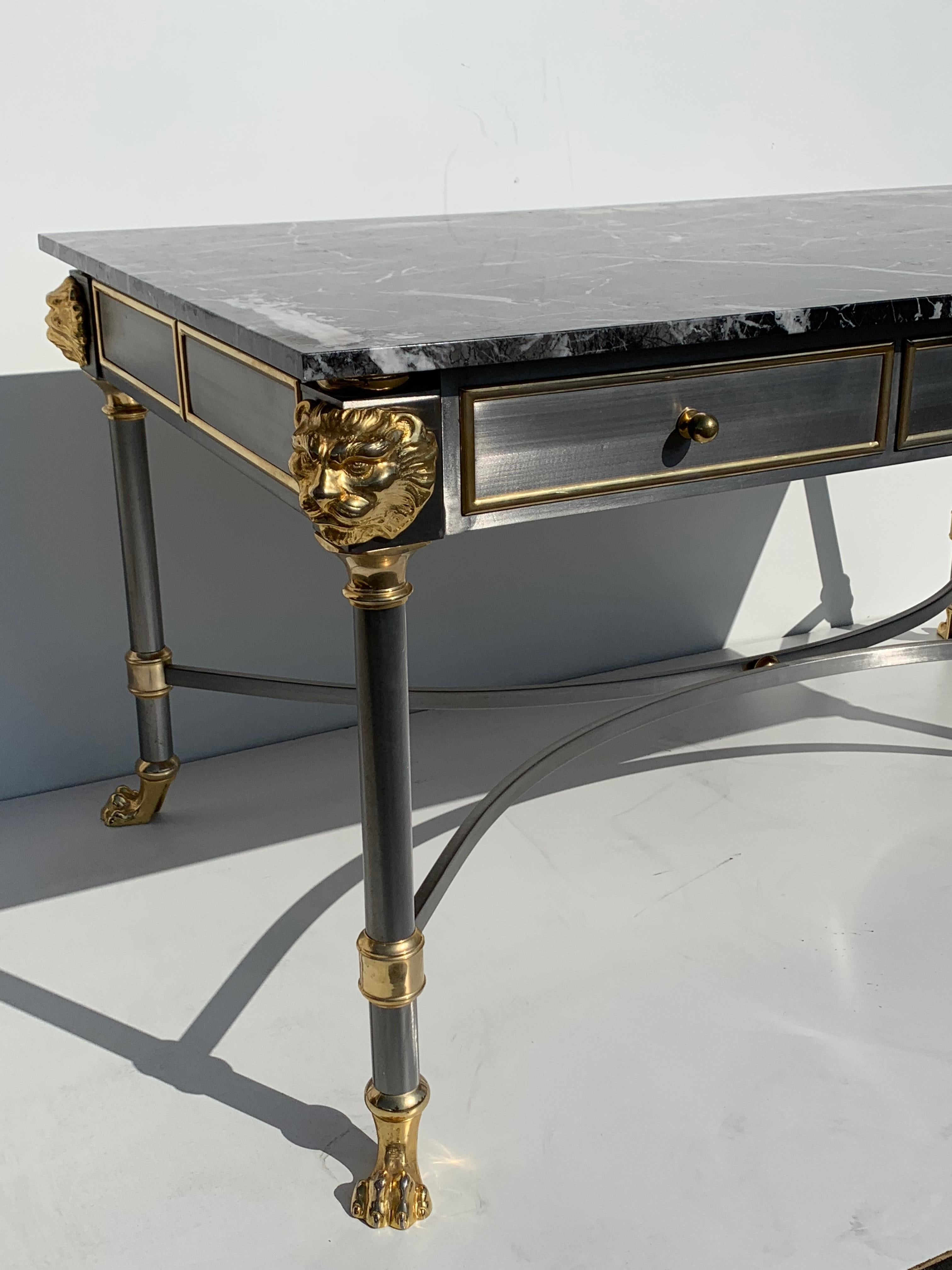  Desk with brushed steel and brass lion motif with marble top in the style of John Vesey Maison Jansen