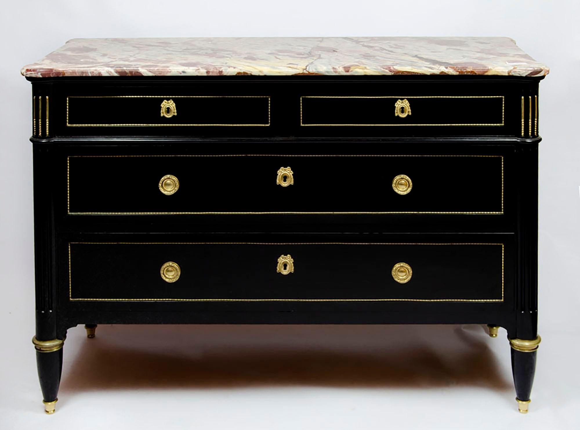 This elegant French dresser or chest of drawers, in the style of Maison Jansen. The Louis XVI-inspired profile with sturdy bronze-trimmed legs contains a set of two-over-two drawers that are also framed in bronze. Tassel-patterned drawer pulls and