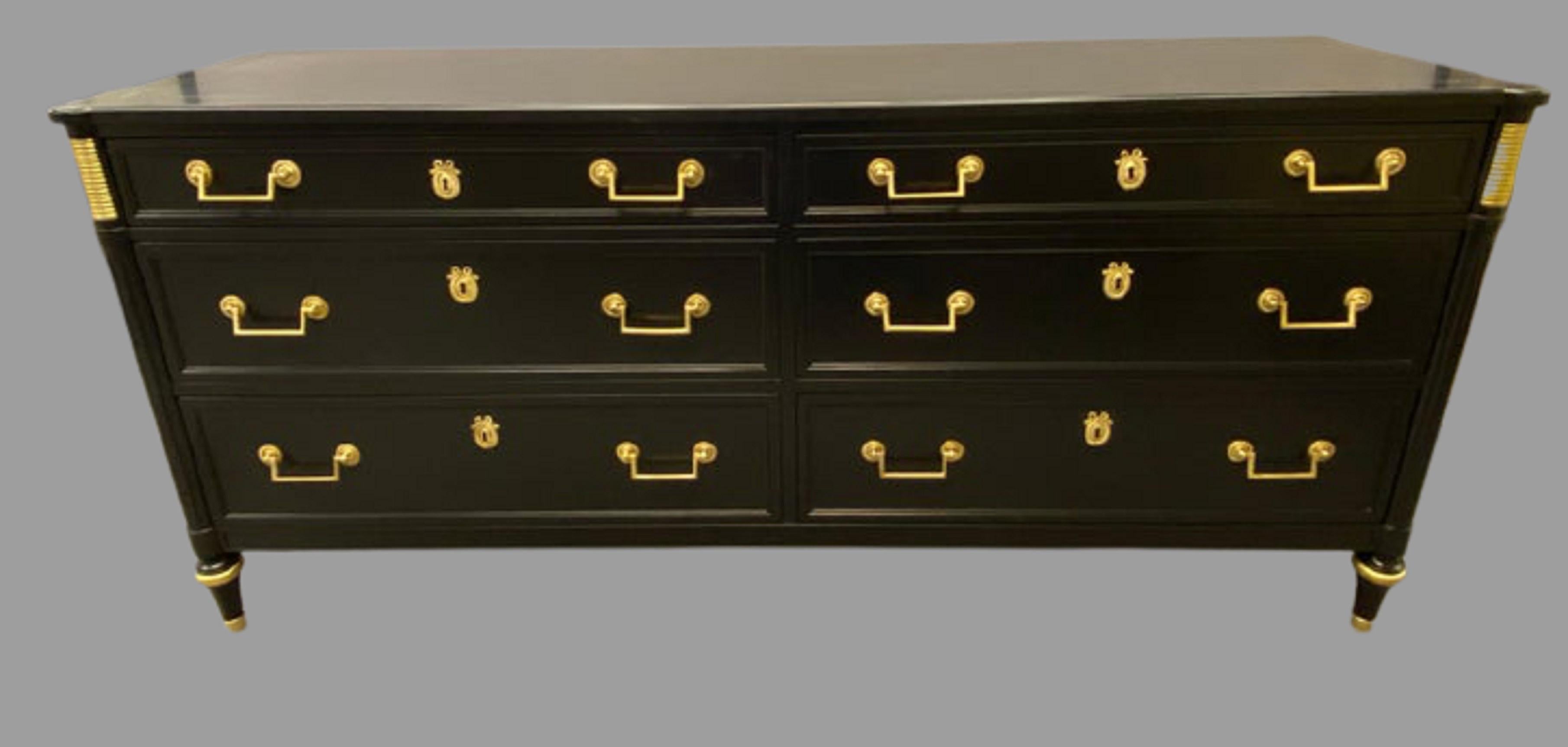 Maison Jansen Style Ebonized Double Dresser. A Hollywood Regency ebony and gilt metal mounted six drawer side by side commode dresser recently refinished. The whole supported by bronze capped and sabot legs.