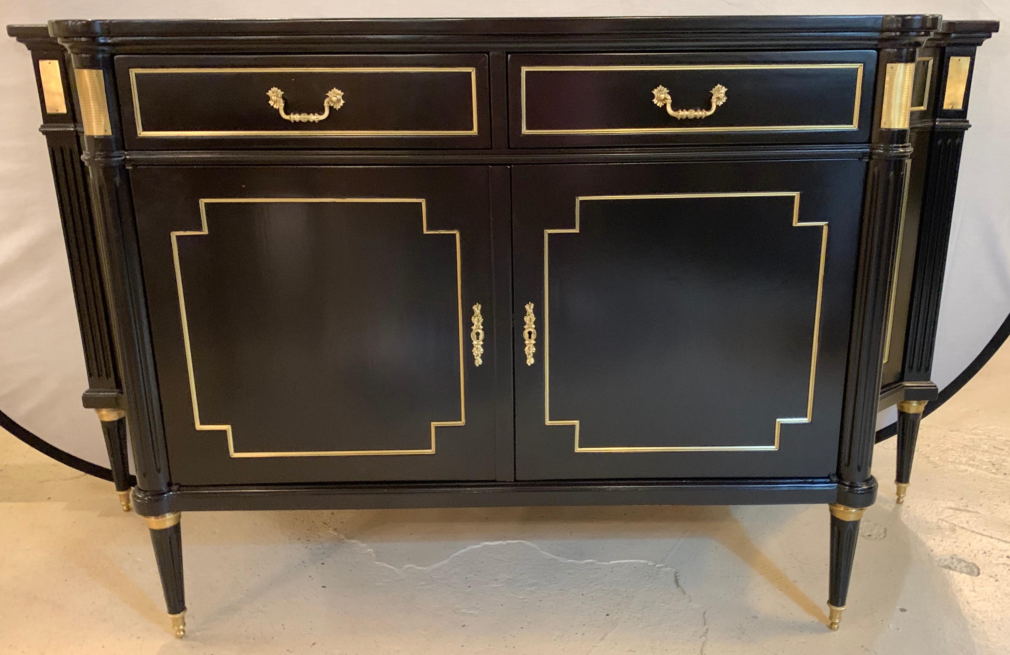 Maison Jansen style ebony sideboard commode cabinet Hollywood Regency era. This wonderful sleek and stylish and cabinet has two bronze framed drawers above two large bronze framed doors. The oak secondary fitted interior with shelves leading to