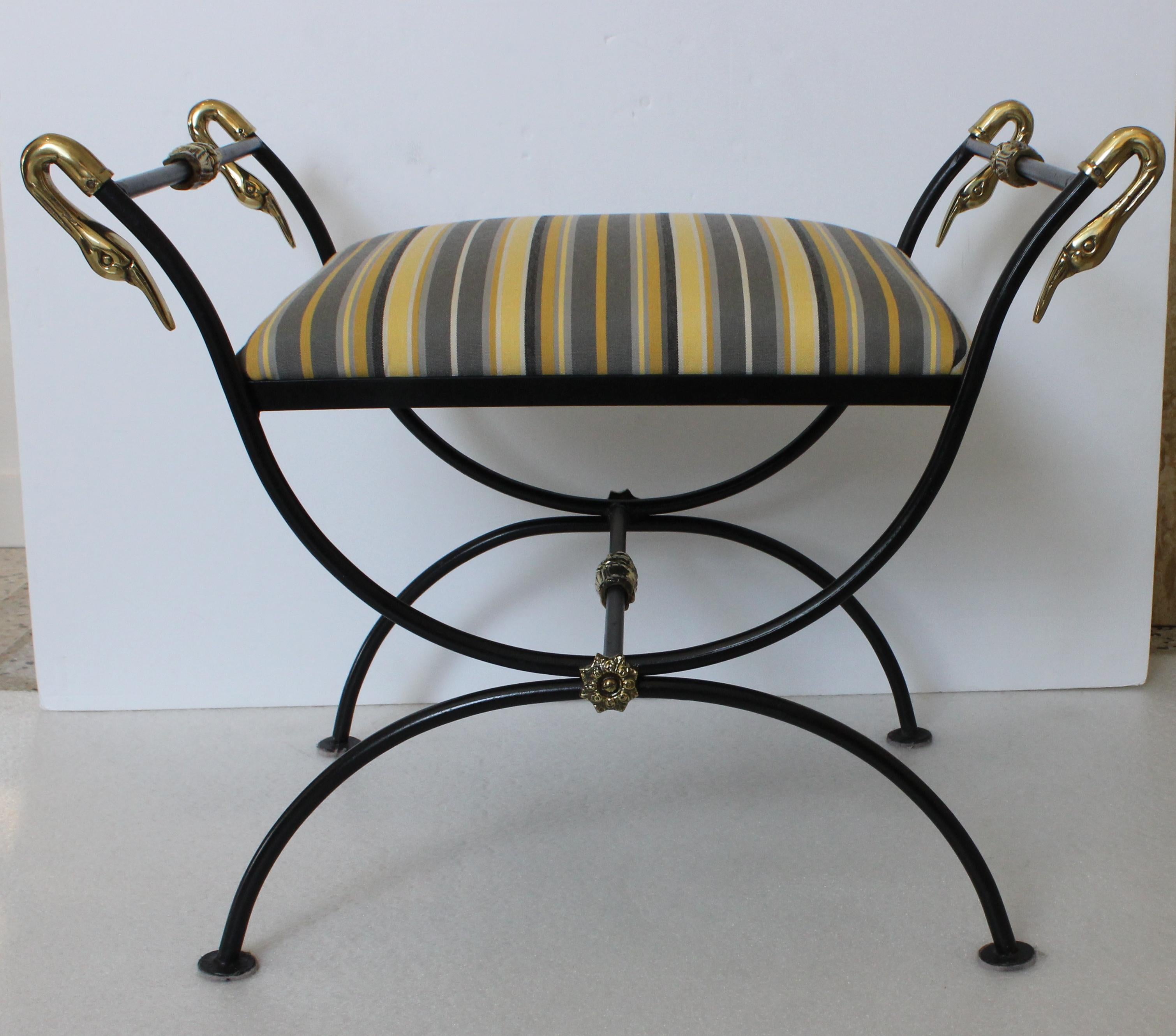 This stylish and chic Maison Jansen style bench is very much in the French Empire revival look with its curule-form, black frame and polished brass swan head and medallions.

Note: The seat cushion is not attached to the frame, and the four