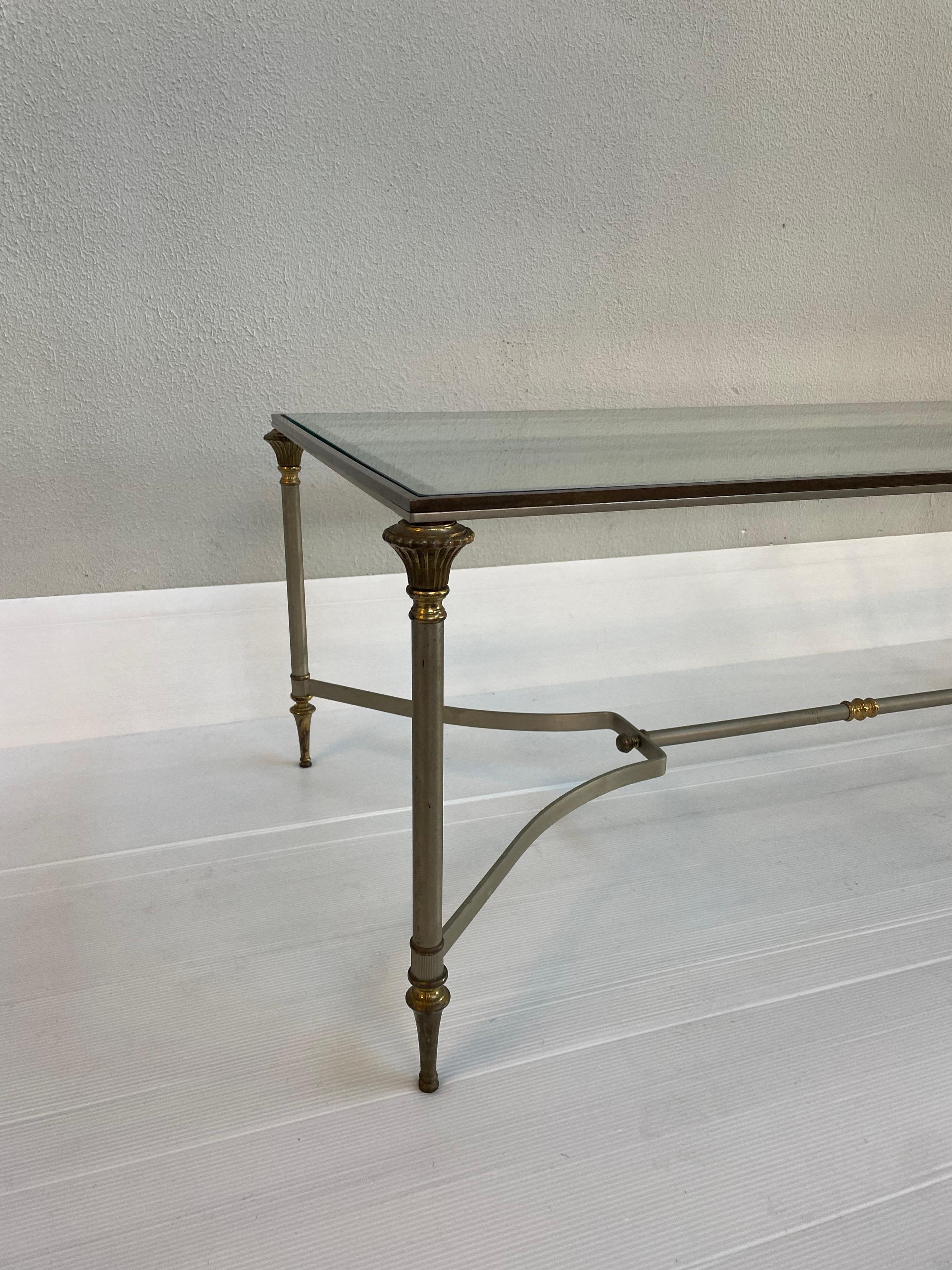 Rectangle coffee table in the style of Maison Jansen featuring stretcher bars with brass details.