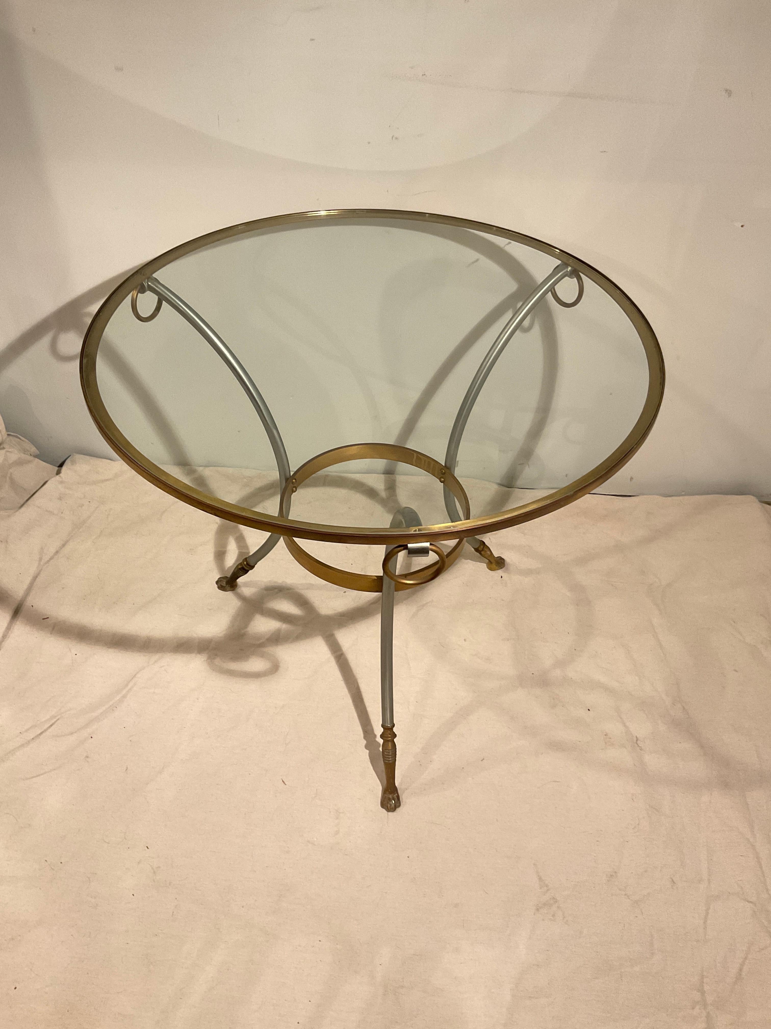 1980s Maison Jansen style Gueridon table. Steel and brass.. Glass top. Made in Italy.