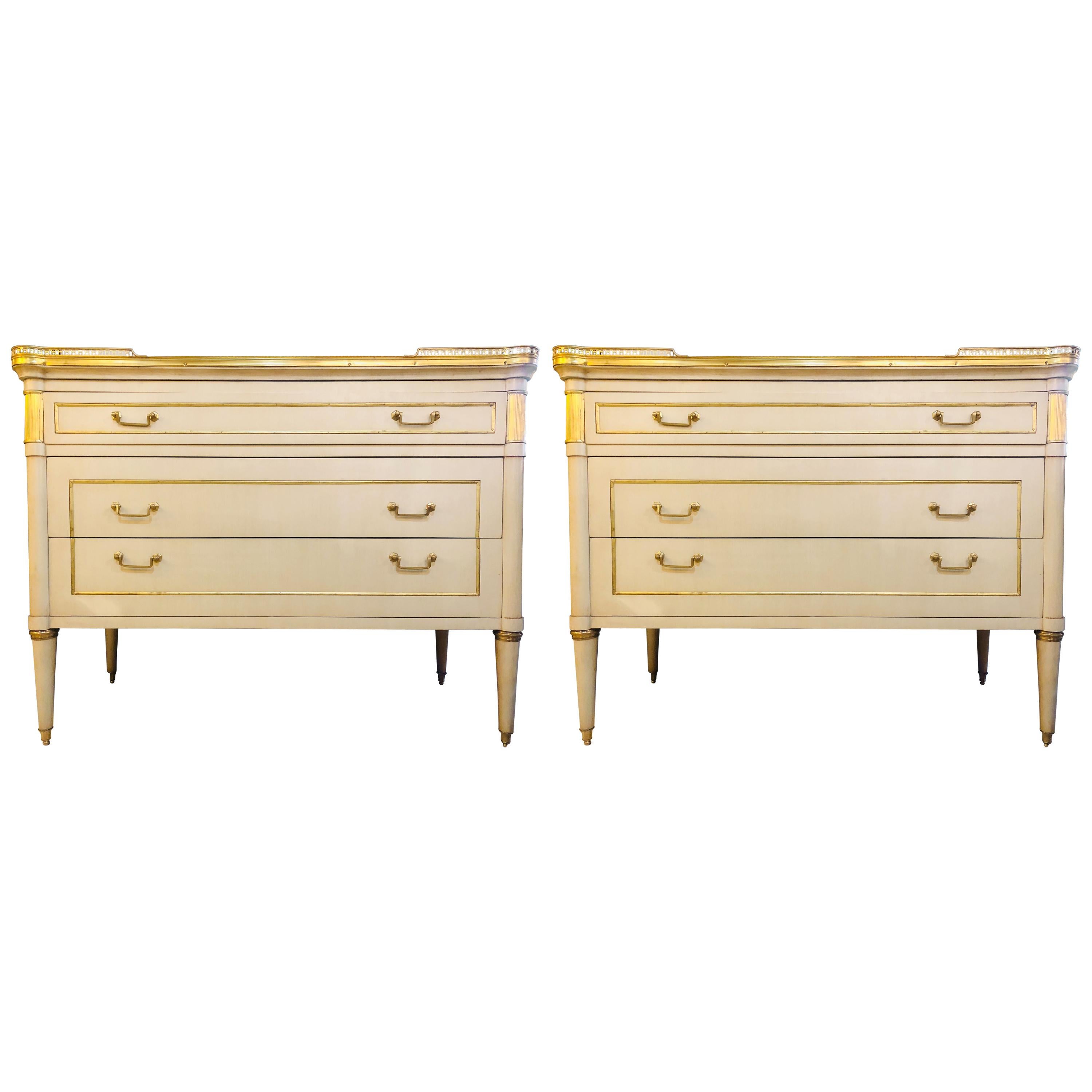 Pair of Maison Jansen style Hollywood Regency marble top mounted cream commodes.
This is a stunning pair of large and impressive paint decorated bronze mounted commodes, nightstands or sideboards in the manner of Maison Jansen that have all the