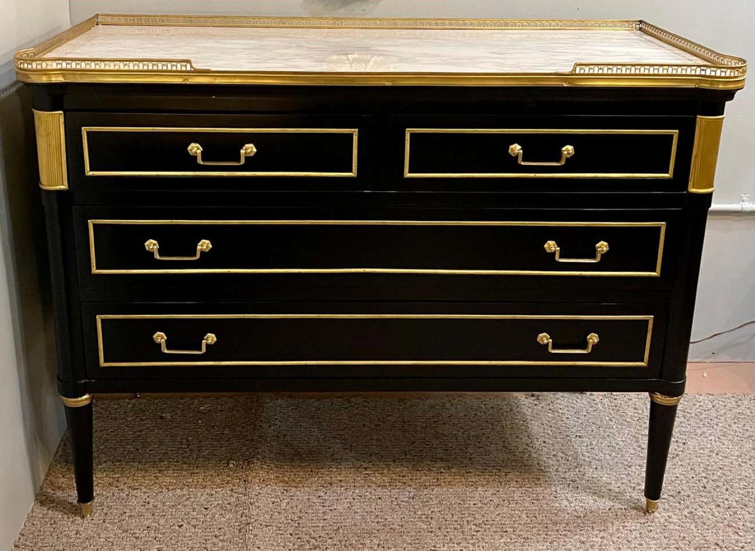Maison Jansen style Hollywood Regency commode, chest or nightstand. A single ebony simply stunning bronze mounted two over two-drawer commode; having a white marble top set in a pierced bronze gallery. The ebony case having rounded corners with