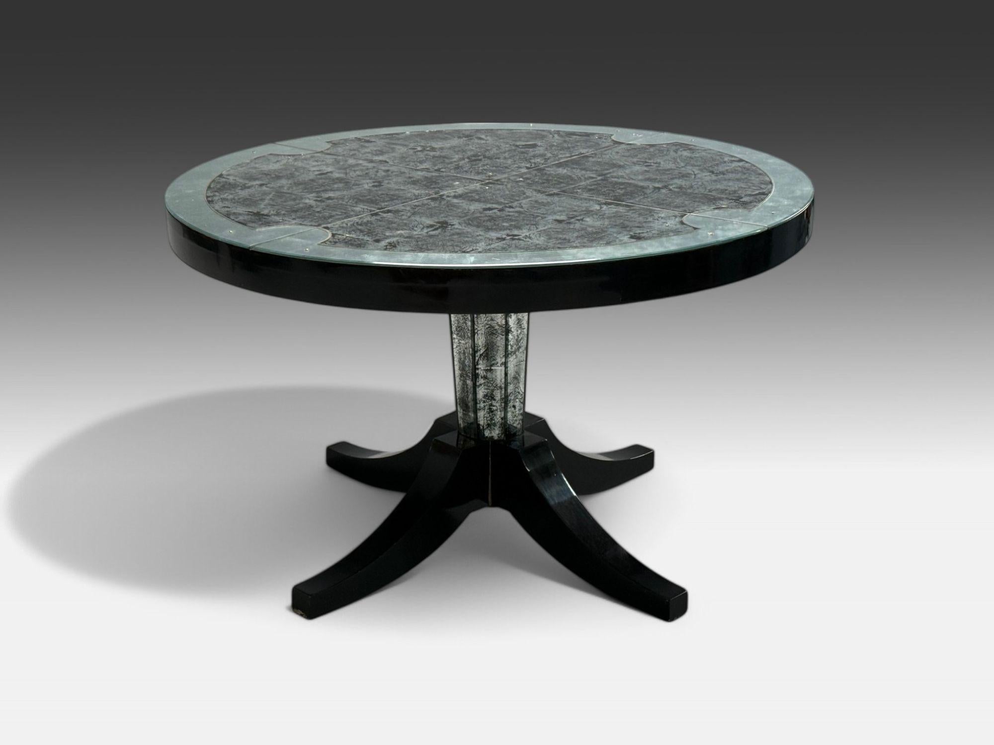 Maison Jansen Style, Hollywood Regency, Distressewd Mirror, Center Table, 20th C.

This elegant and sophisticated center table, likely designed by Maison Jansen, features a striking four-legged pedestal base. The base showcases an eglomise ebony