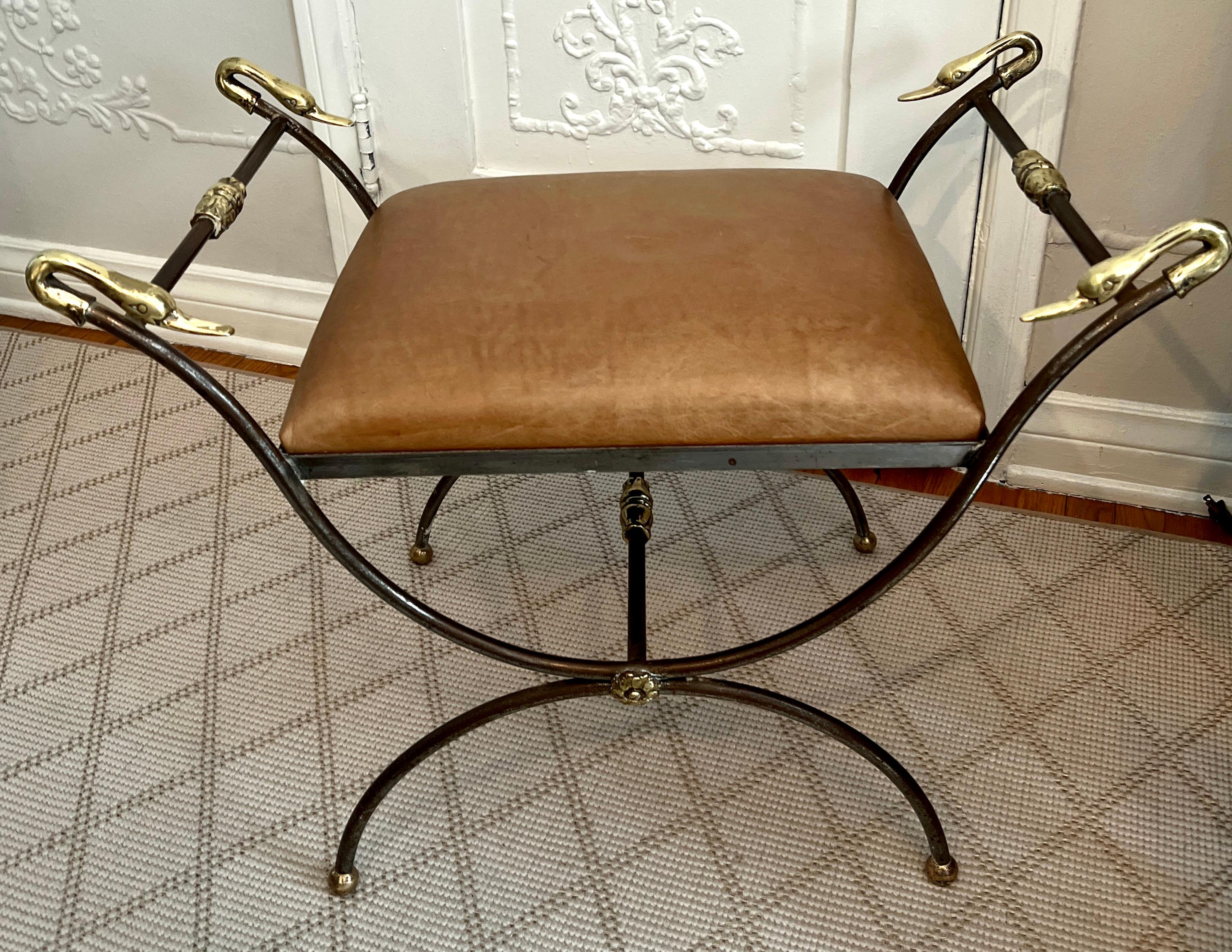 A classic Mid-Century Bench or Ottoman from the 1950'-1960's, or Hollywood Regency.   The inspiration  is from bench that was very much in the French Empire Revival look with its Curule-form.  The leather is a caramel color, however we can fabricate